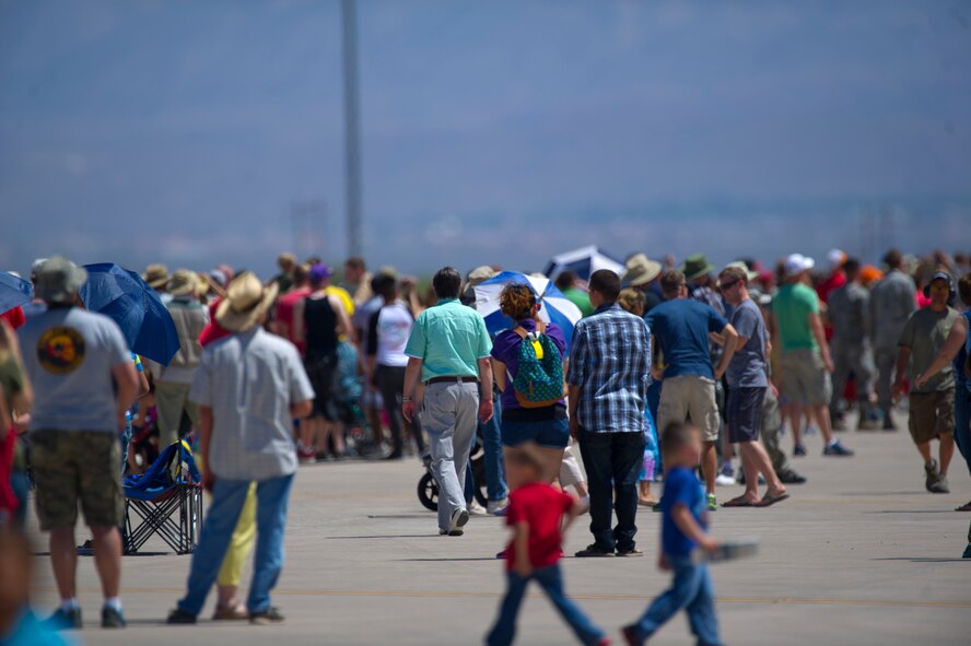 Crowds gather to watch featured aircraft fly over the Tularosa Basin during the Open House event at Holloman Air Force Base, N.M., May 10. Team Holloman hosted an Open House showcasing over 50 aircraft and the day-to-day duties of Holloman Airmen. With live flying demonstrations and static displays, thousands of guests attended the event to get a close-up look at the base’s assets and capabilities. Guests were able to view various aircraft, visit numerous vendors, and witness ground demonstrations from squadrons around the base. (U.S. Air Force photo by Airman 1st Class Chase Cannon/ Released)