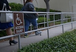Individuals use a wheelchair-accessible ramp May 9 at Joint Base San Antonio-Randolph. JBSA-Randolph has retrofitted many of its historic buildings with handicap-accessible features and designated parking spaces.(U.S. Air Force photo by Joel Martinez)

