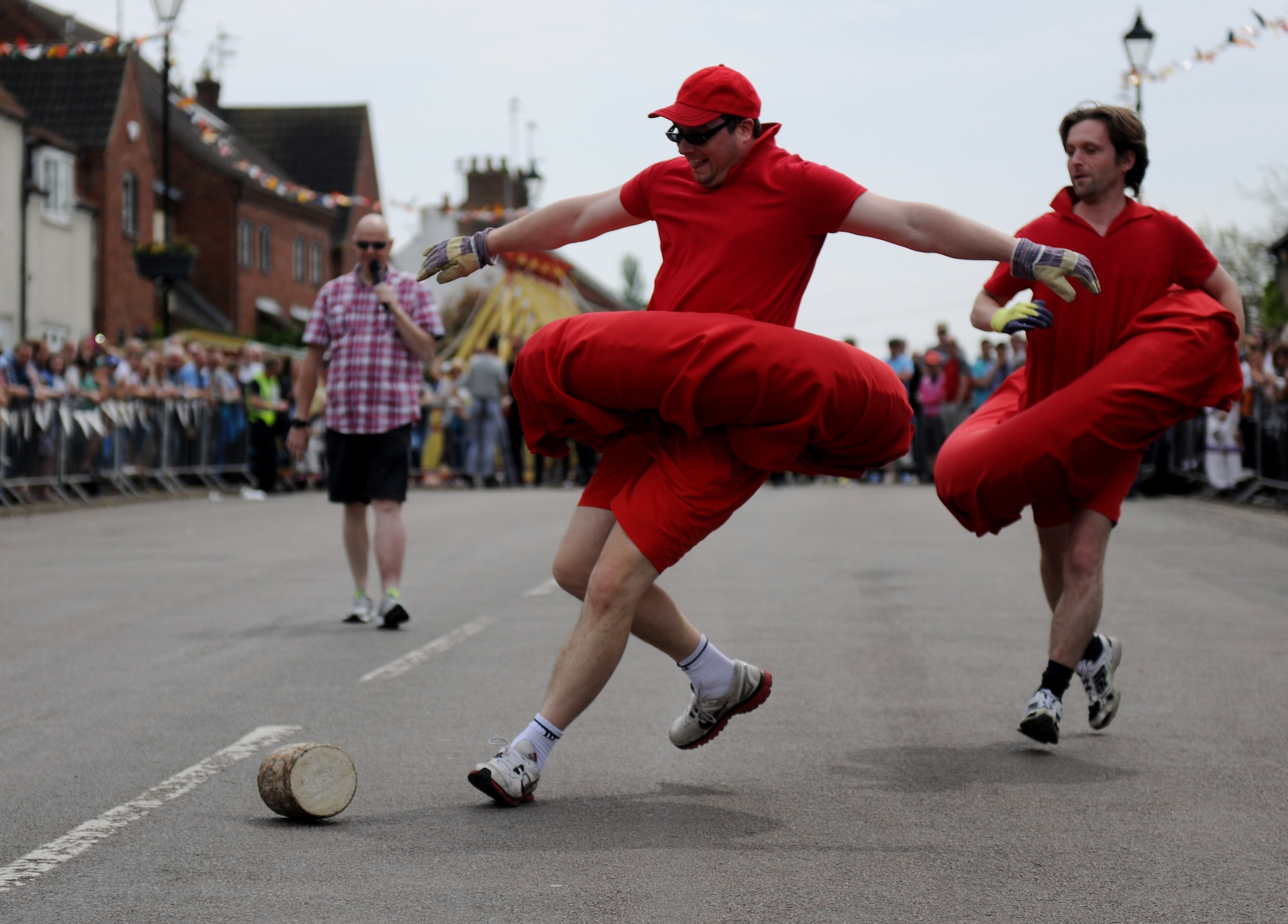 A competitor attempts to keep a wooden log on track during the 50th Annual Stilton Cheese Rolling Festival at Stilton Village, United Kingdom, May 5, 2014. The tradition of cheese rolling began at Stilton in 1964 when local landlords created the event as a means to revive tourism and commerce in the village. (U.S. Air Force photo by Staff Sgt. Jarad A. Denton/Released)