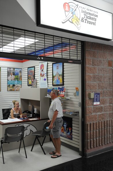 Alyssa Gorby, 56th Force Support Squadron recreation aide, talks with a customer May 2 at the ITT satellite facility located in the Luke Air Force Base Exchange. ITT offers discounted tickets on travel destinations, sporting events and lodging. (U.S. Air Force photo/Staff Sgt. Luther Mitchell Jr.)