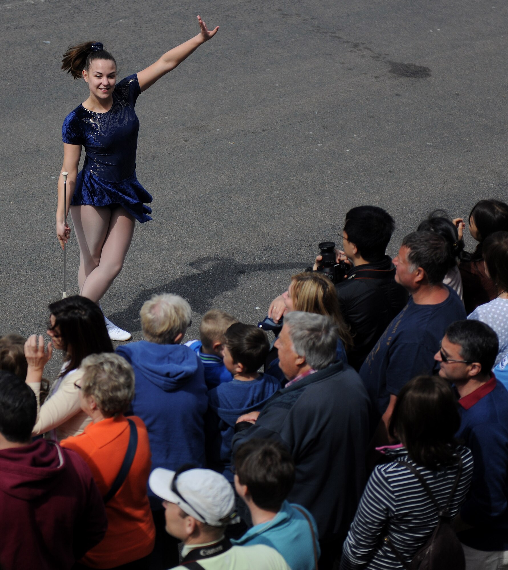 A baton twirler completes her routine during the 50th Annual Stilton Cheese Rolling Festival, Stilton Village, United Kingdom, May 5, 2014. While the festival centers on the tradition of cheese rolling, several local vendors and performers came out to entertain and entice the crowd. (U.S. Air Force photo by Staff Sgt. Jarad A. Denton/Released)