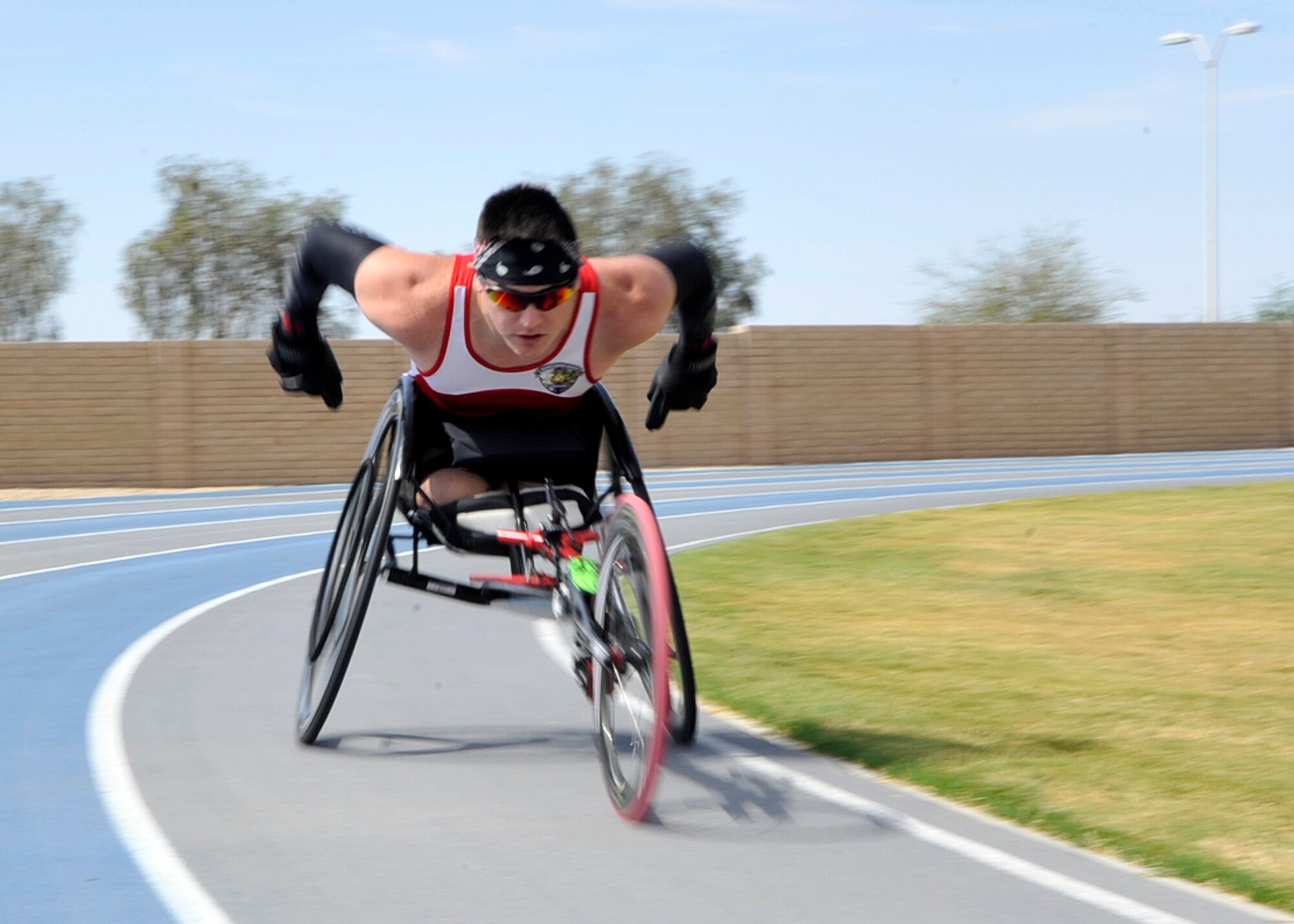 Marine Cpl. Ivan Sears races around the track May 8,2014, on Luke Air Force Base, Ariz. Sears is a fourth generation Marine, who, after being injured in 2010, became a silver and gold medal winner during the Wounded Warrior Games and competed in the Paralympic Desert Challenge in Mesa, Ariz. Sears represents the Marine Corps during training but also works with wounded warrior families at Fort Sam Houston, San Antonio, Texas. (U.S. Air Force photo/Senior Airman Marcy Copeland)    