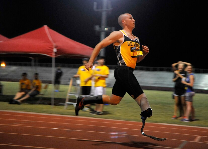 Sgt. Ryan McIntosh runs across the finish line Saturday at Red Mountain High School in Mesa. McIntosh competed in the 100-meter, 200-meter and long jump during the Desert Challenge in Mesa. (U.S. Air Force photo/Senior Airman Marcy Copeland)