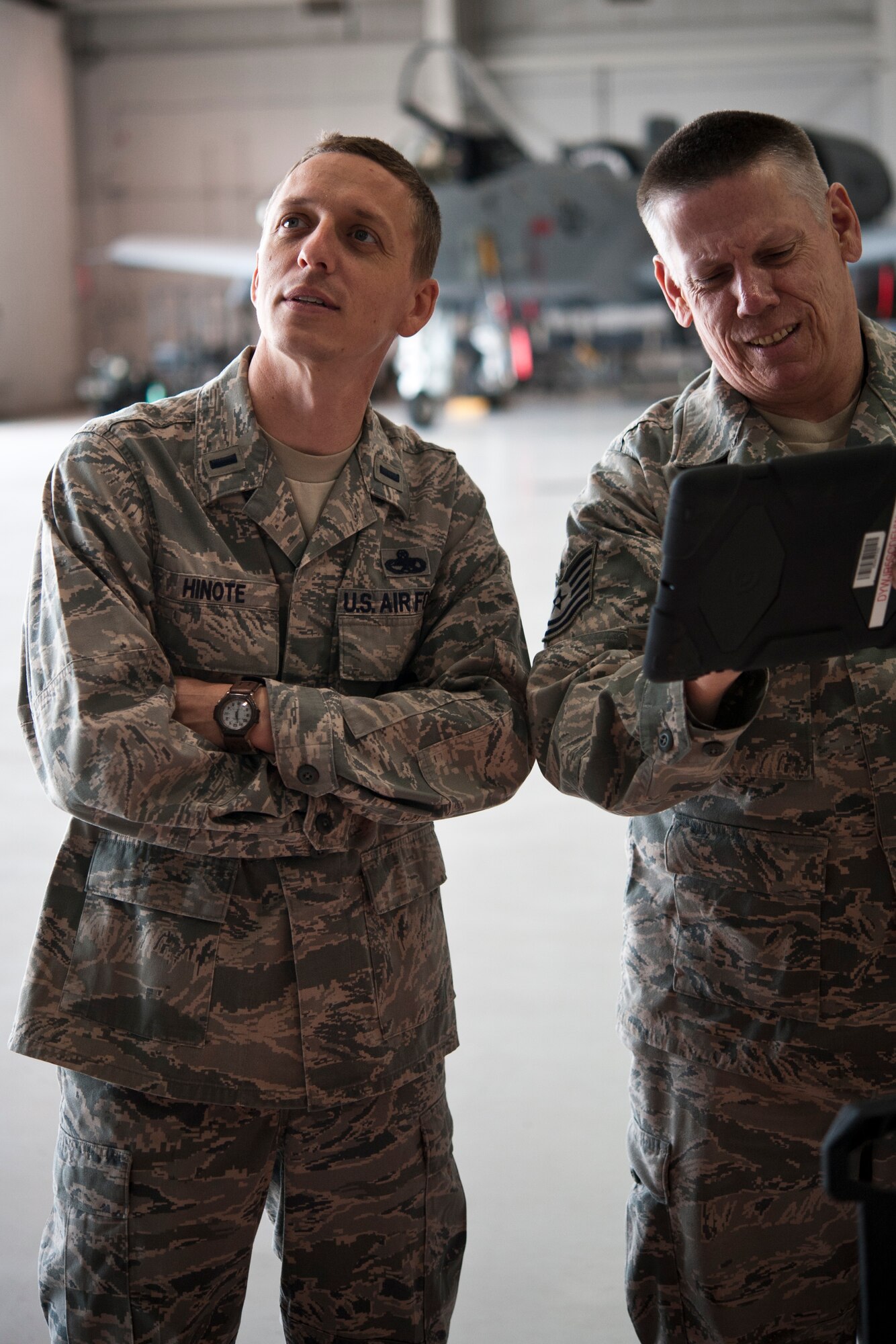 1st Lt. Chris Hinote, 442nd Aircraft Maintenance Squadron officer, goes over tasking orders with Tech. Sgt. Dave Ward, 717th Aircraft Maintenance Squadron electro-environmental technician, May 14, 2014, at Whiteman Air Force Base, Missouri. Hinote was the Company Grade Officer of the Quarter for the first quarter of 2014. (U.S. Air Force photo by Senior Airman Daniel Phelps/Released)