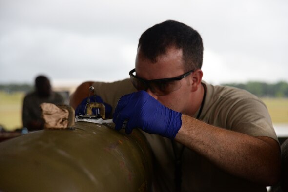 U.S. Air Force Staff Sgt. Kevin Canady, 20th Equipment Maintenance Squadron munitions flight munitions inspector, glues down a pin on a MK-82 missile during live bomb build at Shaw Air Force Base, S.C., May 15, 2014. This was the first time since 2012 that the munitions flight has done a live bomb build. (U.S. Air Force photo by Airman 1st Class Michael A. Cossaboom/Released)