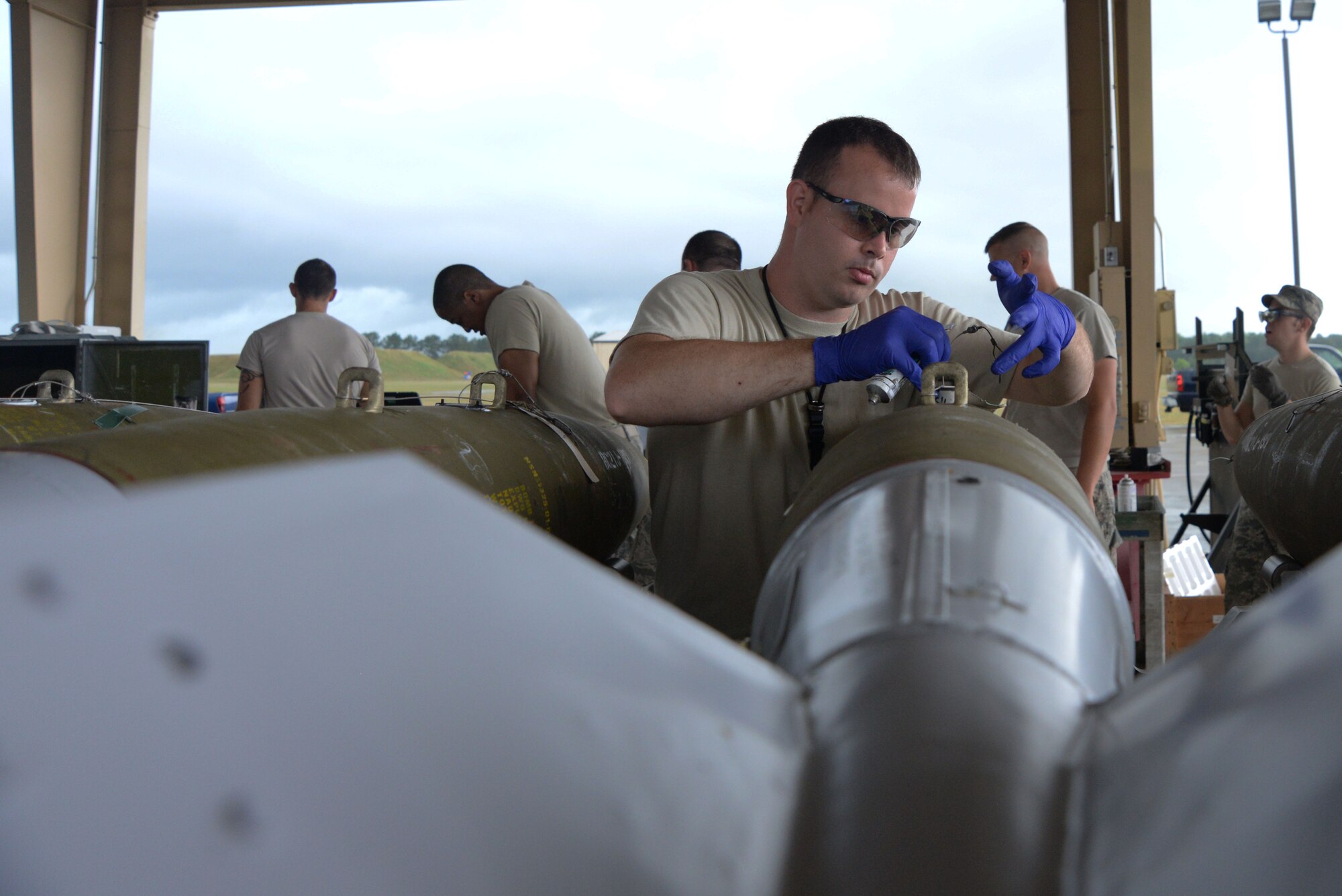U.S. Air Force Staff Sgt. Kevin Canady, 20th Equipment Maintenance Squadron munitions flight munitions inspector, attaches an arm wire to a MK-82 missile during a live bomb build at Shaw Air Force Base, S.C., May 15, 2014. The bomb weighs approximately 500 pounds, making it one of the smallest missiles in the U.S. arsenal.  (U.S. Air Force photo by Airman 1st Class Michael A. Cossaboom/Released)
