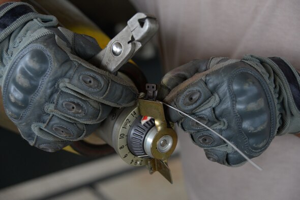 U.S. Air Force Senior Airman Jarrett Pellazar, 20th Equipment Maintenance Squadron munitions flight munitions accountability technician, tightens the arming wire on a MK-82 missile during a live bomb build at Shaw Air Force Base, S.C., May 15, 2014. The MK-82 is an unguided, low-drag general-purpose bomb, part of the U.S. MK-80 series, and are used for training purposes by Shaw AFB F16-CJ Fighting Falcons. (U.S. Air Force photo by Airman 1st Class Michael A. Cossaboom/Released)