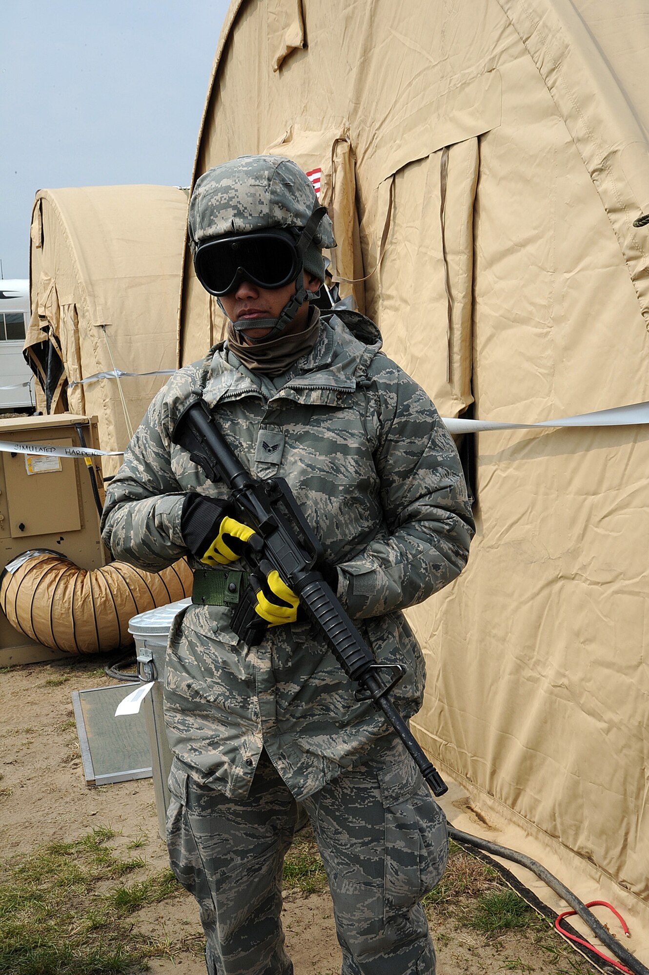 U.S. Air Force Senior Airman Arnold Cruz, a medic with the 349th Aeromedical Staging Squadron, Travis AFB, Calif., is assigned security detail at the En/Route Patient Staging System, Young Air Assault Strip on May 7, 2014 during exercise Patriot Warrior at Fort McCoy, Wis. (U.S. Air Force photo by Master Sgt. Francisco V. Govea II/ Released)