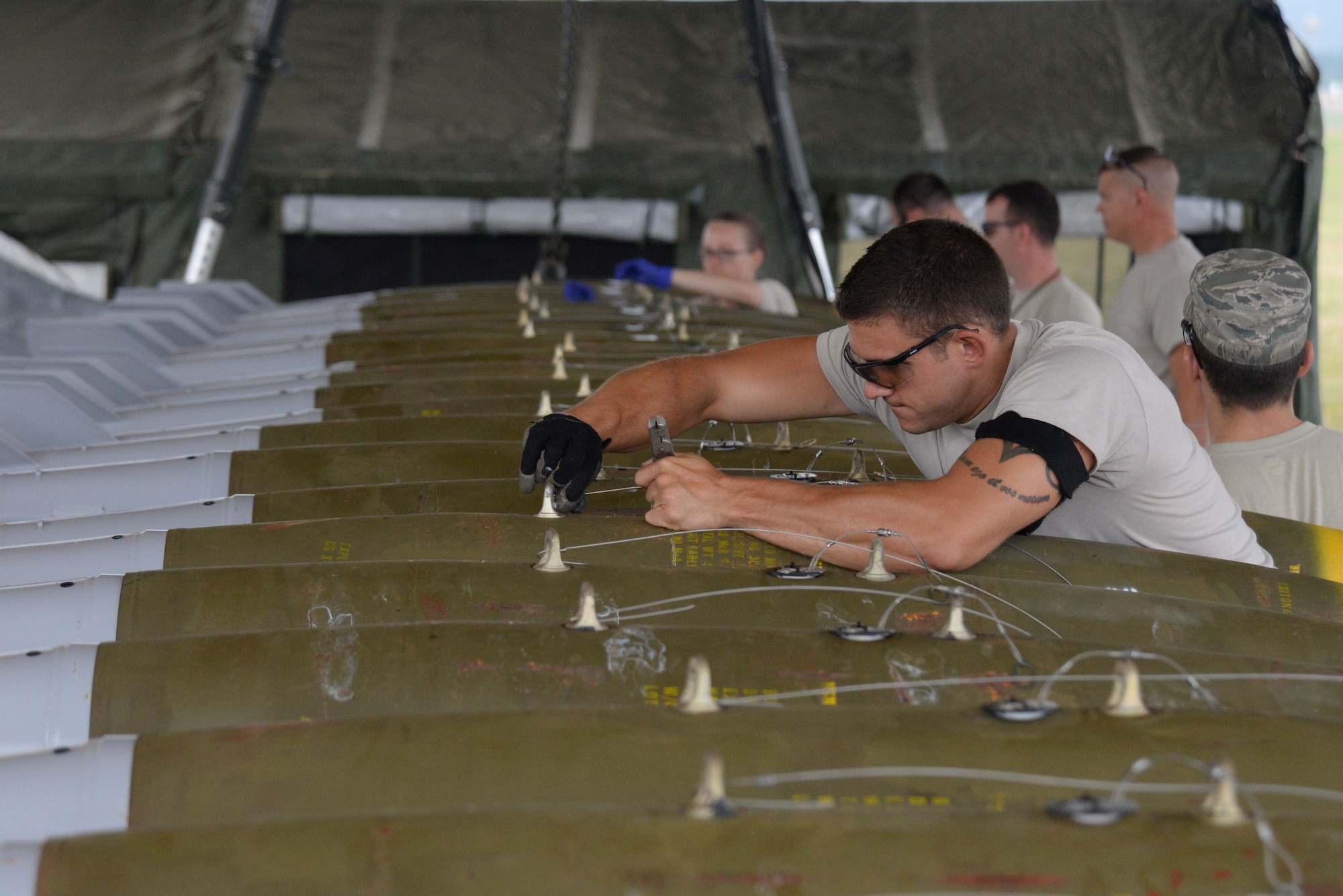 U.S. Air Force Staff Sgt. Daniel Brock, 20th Equipment Maintenance Squadron munitions flight conventional maintenance crew chief, tightens down an arming wire on a MK-82 slick missile during a live bomb build at Shaw Air Force Base, S.C., May 15, 2014. Brock and his team assembled 12 bombs that Team Shaw pilots will use will on training missions. (U.S. Air Force photo by Airman 1st Class Michael A. Cossaboom/Released)