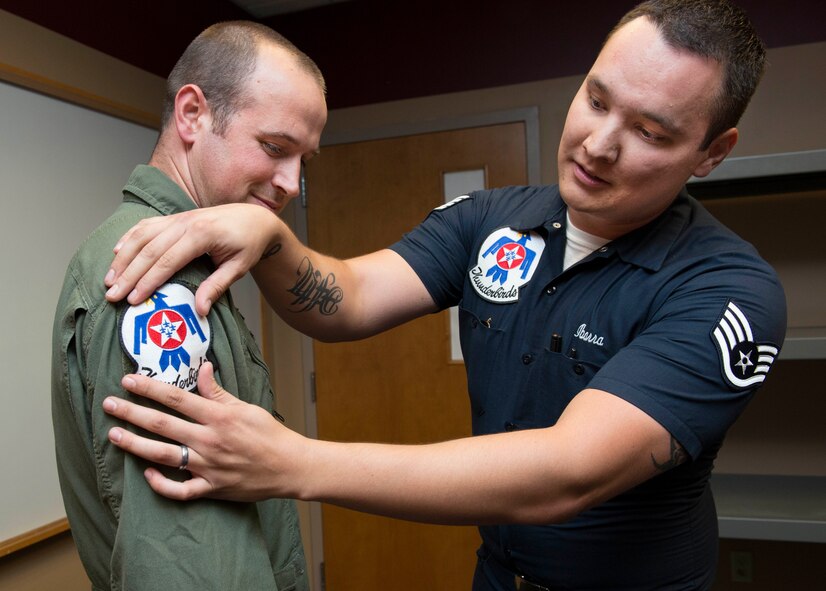 Jackson Harris, a Solano County sheriff’s deputy, receives an official U.S. Air Force Thunderbirds patch May 1, at Travis Air Force Base, Calif. Harris served as the installation’s “Hometown Hero” for the 2014 Travis Air Expo. (U.S. Air Force photo by Heide Couch)