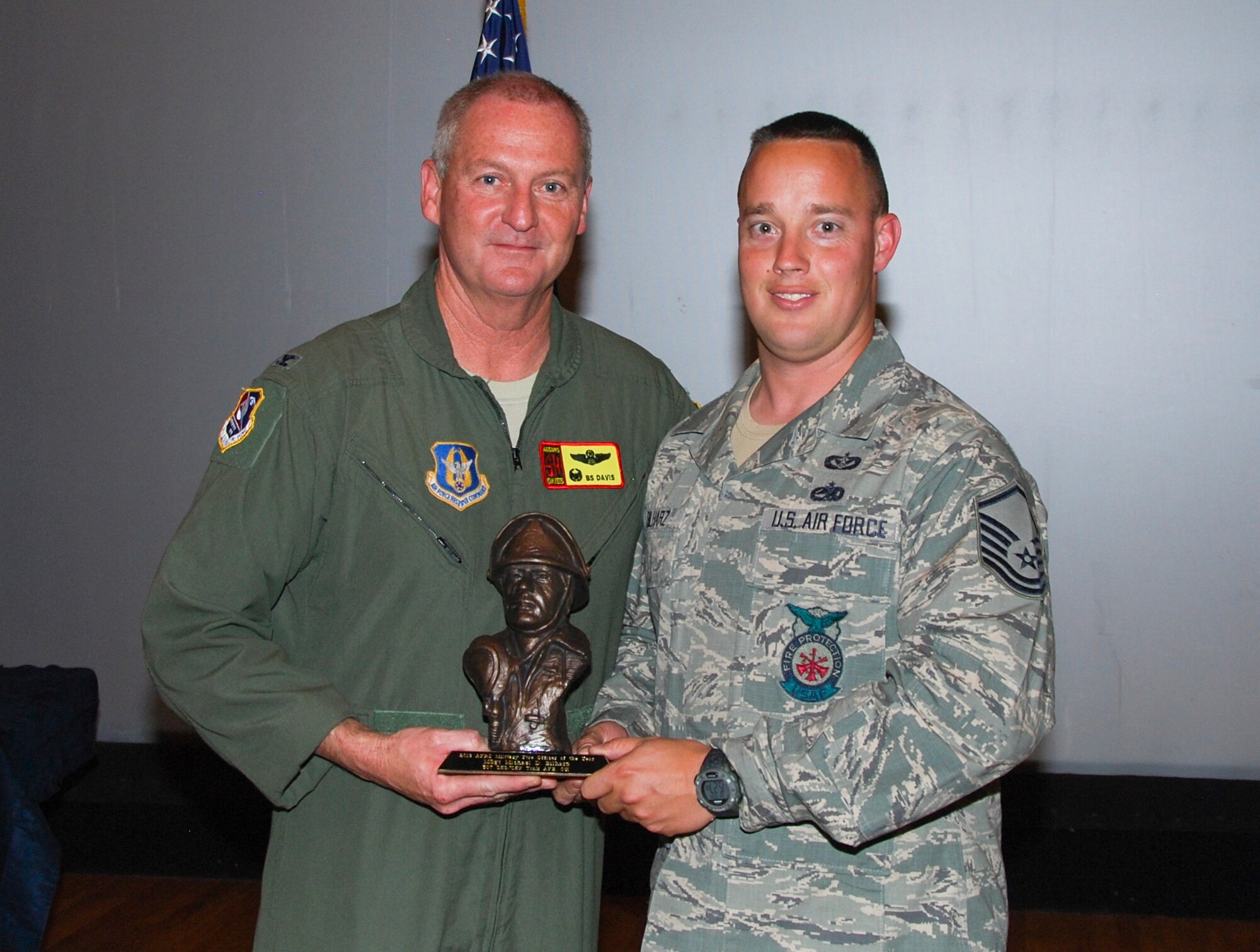 Colonel Brian S. Davis, 507th Air Refueling Wing commander, presents the AFRC Fire Officer of the Year award to Master Sgt. Michael D. Bilharz during commander’s call on May 4, 2014. He was selected for this award due to his superior job performance and outstanding contributions to the fire service.  (U.S. Air Force photo/Staff Sgt. Charles Taylor)