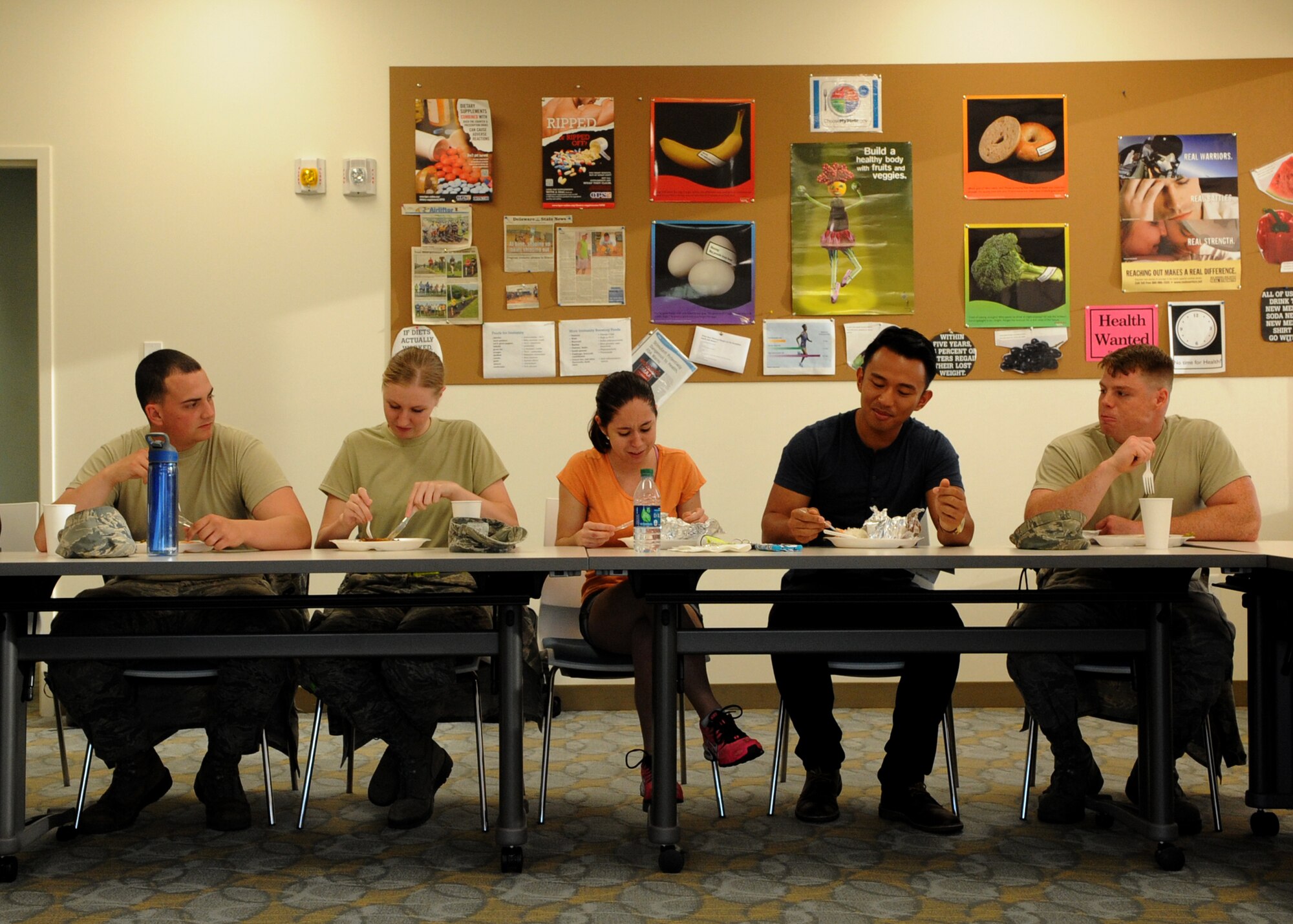 Airmen from the 436th Airlift Wing eat a meal that was prepared in a Dorm to Gourm cooking class at the Health and Wellness Center May 13, 2014 at Dover Air Force Base, Del. The Airmen prepared an appetizer, a main course and a dessert. (U.S. Air Force photo/Staff Sgt. Elizabeth Morris)