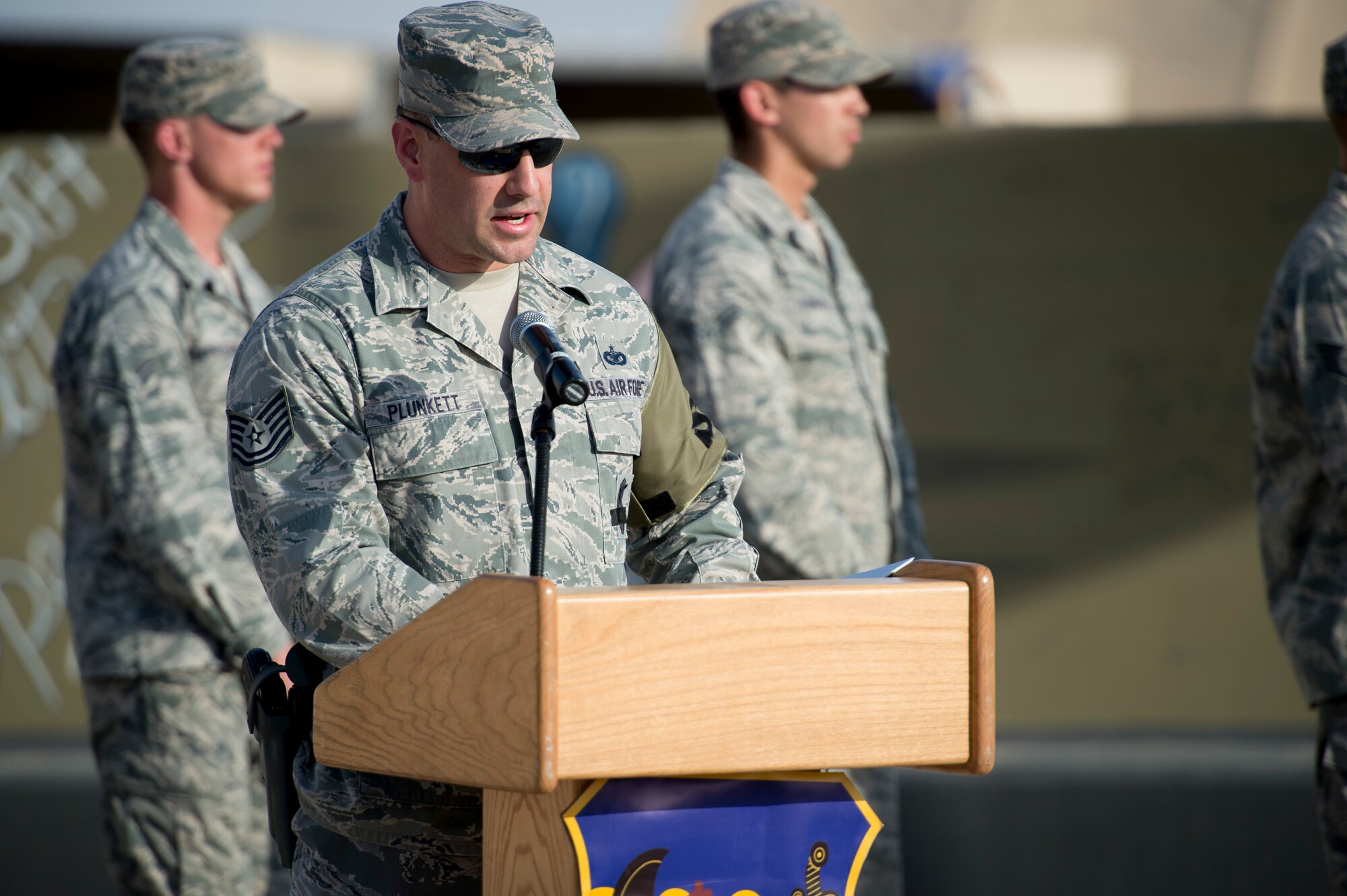 Tech Sgt. Matthew Plunkett, 386th Expeditionary Security Forces Squadron, speaks to participants during a formal retreat ceremony on May 15, 2014 at an undisclosed location in Southwest Asia. Members came to pay their respects for a national Police Officer Memorial Day dedicated to all civilian and law enforcement members who have given their lives in the line of duty. (U.S. Air Force photo by Staff Sgt. Jeremy Bowcock)