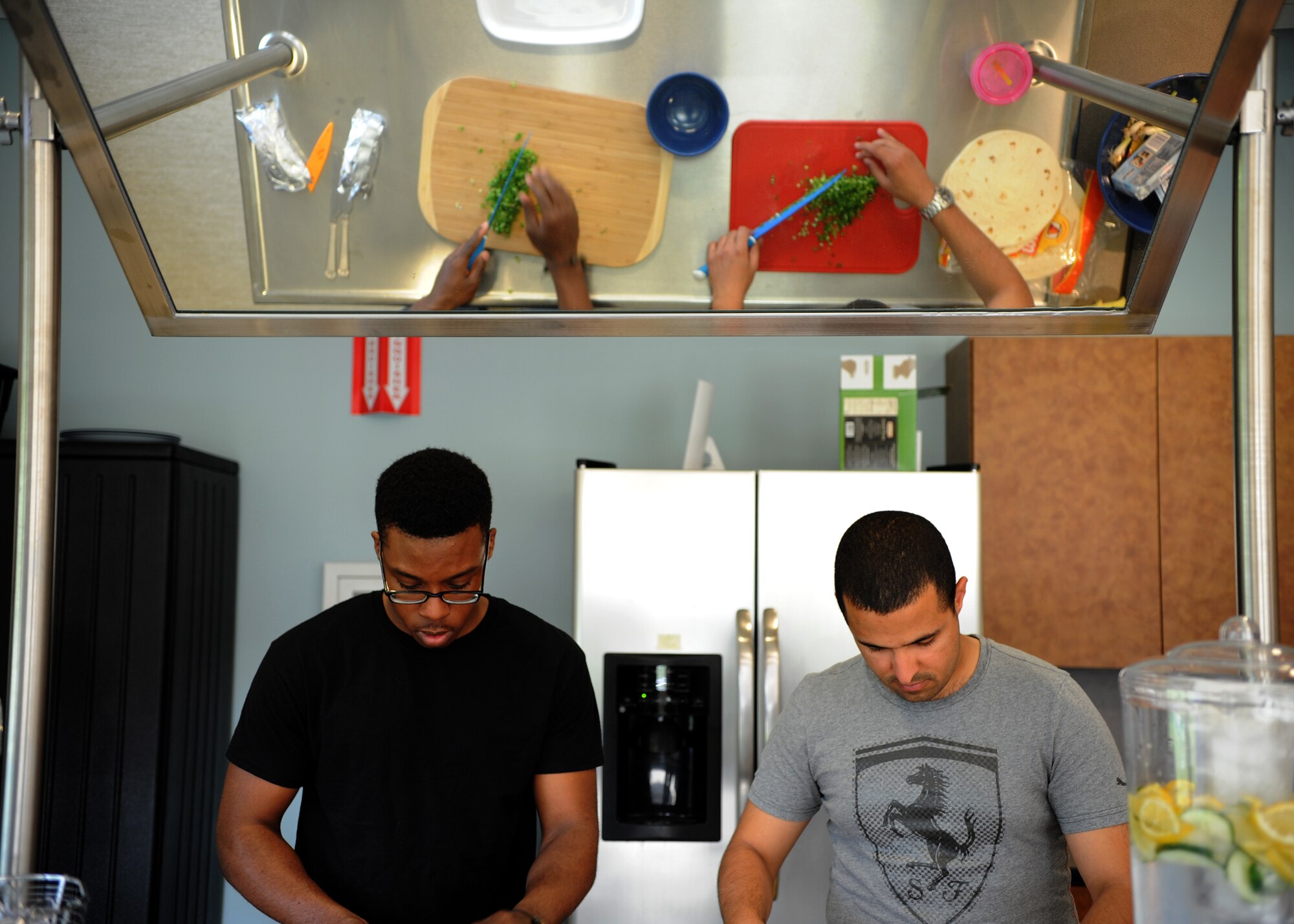 Airman 1st Class Brandon Henry, 436th Aircraft Maintenance Squadron crew chief, and A1C Alan Mejia, 436th Aerospace Medicine Squadron public health technician, prepare ingredients for a meal for Dorm to Gourm at the Health and Wellness Center May 13, 2014 at Dover Air Force Base, Del. Airmen have the opportunity to prepare appetizers, main courses and desserts during the class.(U.S. Air Force photo/Staff Sgt. Elizabeth Morris)