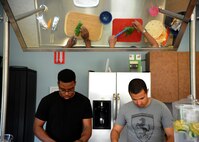 Airman 1st Class Brandon Henry, 436th Aircraft Maintenance Squadron crew chief, and A1C Alan Mejia, 436th Aerospace Medicine Squadron public health technician, prepare ingredients for a meal for Dorm to Gourm at the Health and Wellness Center May 13, 2014 at Dover Air Force Base, Del. Airmen have the opportunity to prepare appetizers, main courses and desserts during the class.(U.S. Air Force photo/Staff Sgt. Elizabeth Morris)