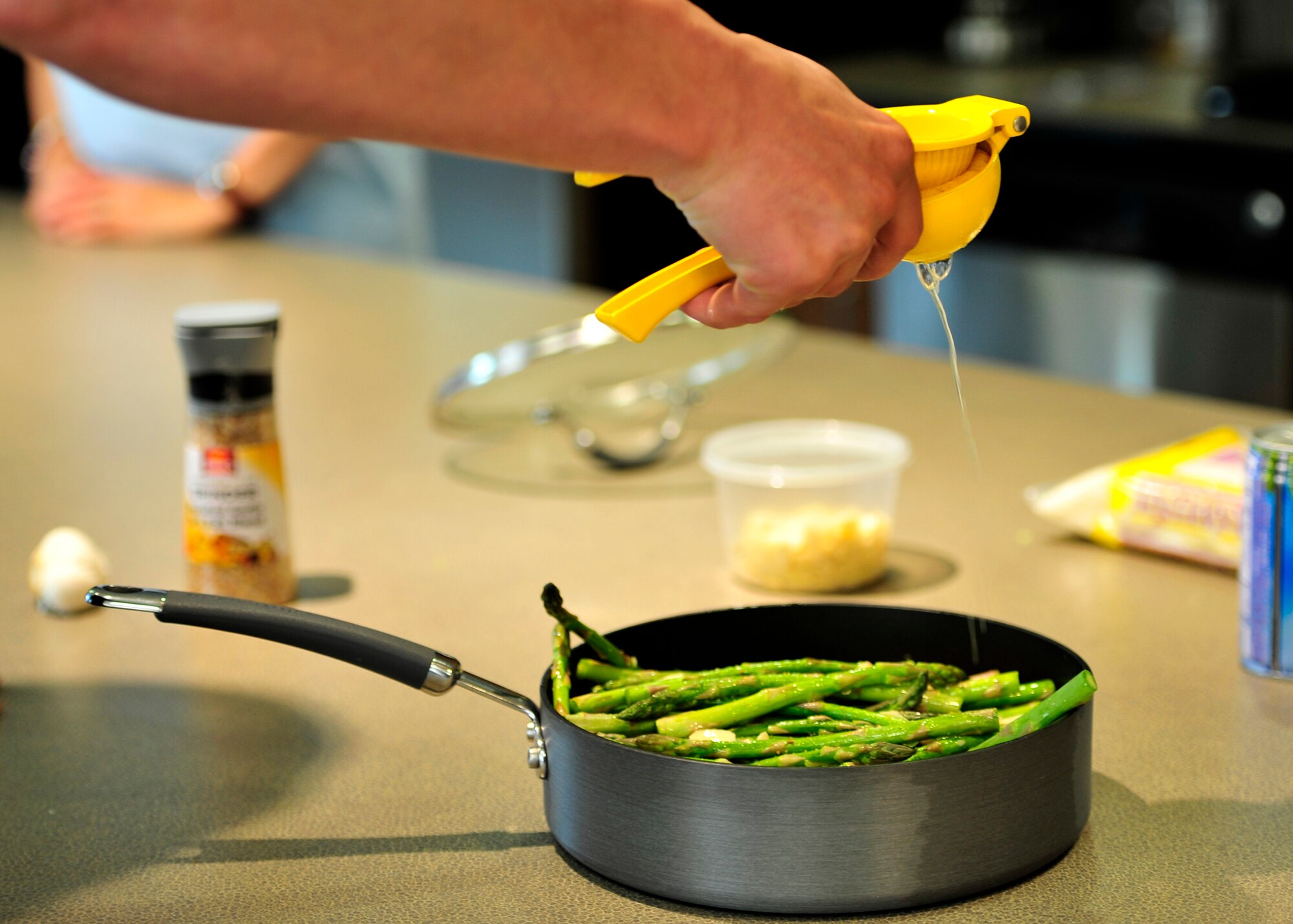 An Airman juices a lemon during a Dorm to Gourm cooking class May 13, 2014 at Dover Air Force Base, Del. Dorm to Gourm is offered to dorm residents and takes place at the Health and Wellness Center. (U.S. Air Force photo/Staff Sgt. Elizabeth Morris)