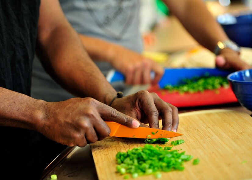 Airmen from the 436th Airlift Wing prepare ingredients for Dorm to Gourm at the Health and Wellness Center May 13, 2014 at Dover Air Force Base, Del. Dorm to Gourm is a class offered to dorm residents that teaches them how to prepare healthy and delicious meals. (U.S. Air Force photo/Staff Sgt. Elizabeth Morris)