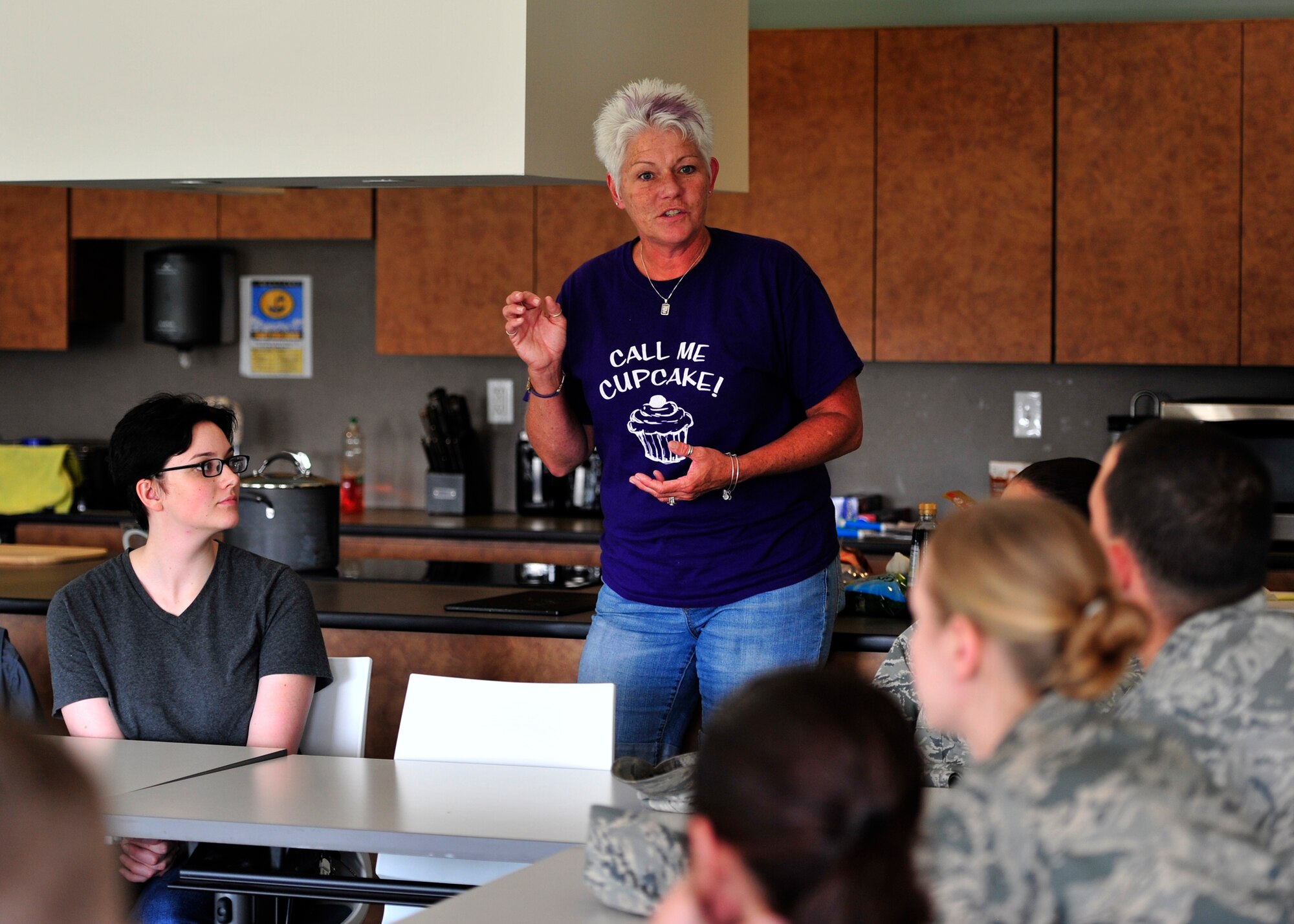 Dawne Nickerson, 2014 Dover Air Force Base honorary commander and sponsor of Dorm to Gourm, speaks to Airmen about the meal they are going to prepare during a class May 13, 2014 at DAFB, Del. Dorm to Gourm is a cooking class offered to dorm residents and is held at the Health and Wellness Center. (U.S. Air Force photo/Staff Sgt. Elizabeth Morris)