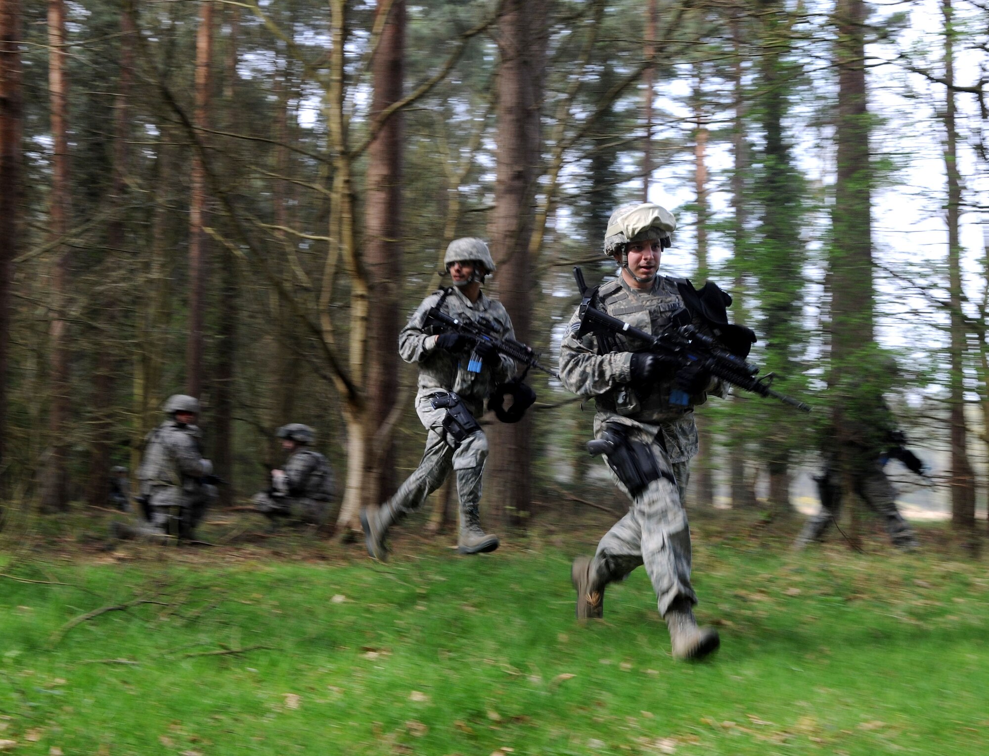 U.S. Air Force Senior Airmen Christopher Barile and Christopher Morales, 48th Security Forces Squadron defenders, take their positions as guards for the rest of the Airmen on patrol April 3, 2014, during a training exercise at Stanford Training Area near Thetford, England. Security forces Airmen must conduct 40 hours of combat-readiness training before attending an additional training course. The training includes land navigation, dismounted and mounted patrols, small team tactics, convoy operations and fire control measures. (U.S. Air Force photo by Senior Airman Kate Maurer/Released) 