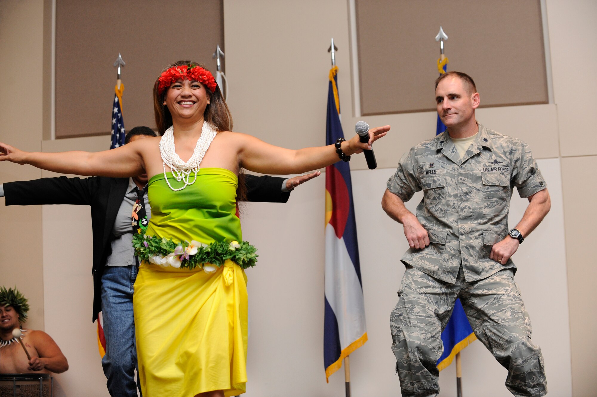 Team Buckley members learn traditional pacific-island dances during Buckley’s Asian-American Pacific Islander Heritage Month Celebration May 14, 2014, at the leadership development center on Buckley Air Force Base, Colo. The ceremony also included a guest speaker, traditional pacific island and Asian food samples, and dances performed by the Polynesian dance troupe, Halau Kalama. (U.S. Air Force photo by Airman 1st Class Samantha Saulsbury/Released)