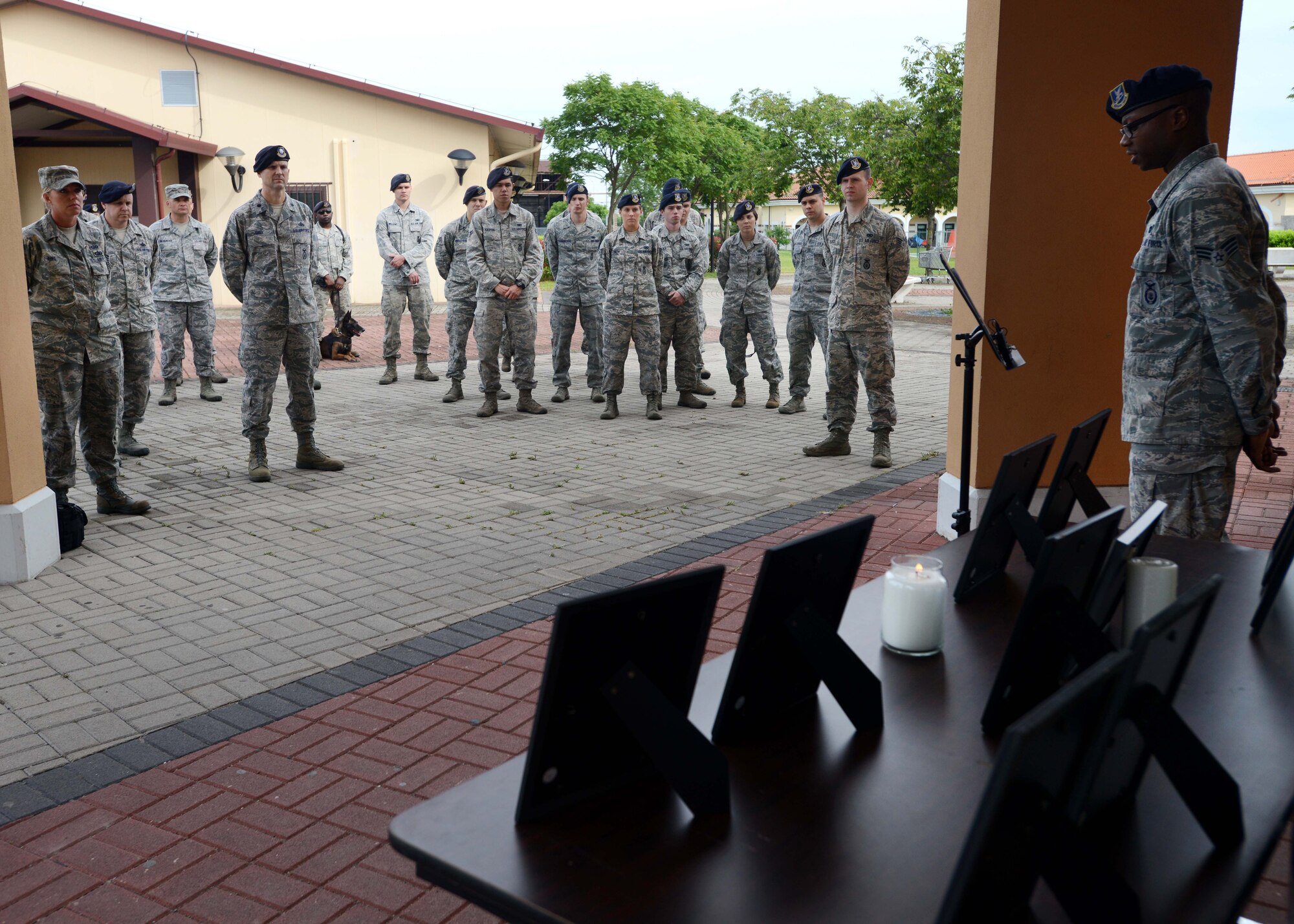 Senior Airman Keylon Wilbert, 31st Security Forces Squadron security response team member, leads Airmen during a candlelight vigil for Police Week, May 13, 2014, at Aviano Air Base, Italy. Police Week serves to remember law enforcement officials who paid the ultimate sacrifice and those who are still serving.  (U.S. Air Force photo/Airman 1st Class Deana Heitzman)