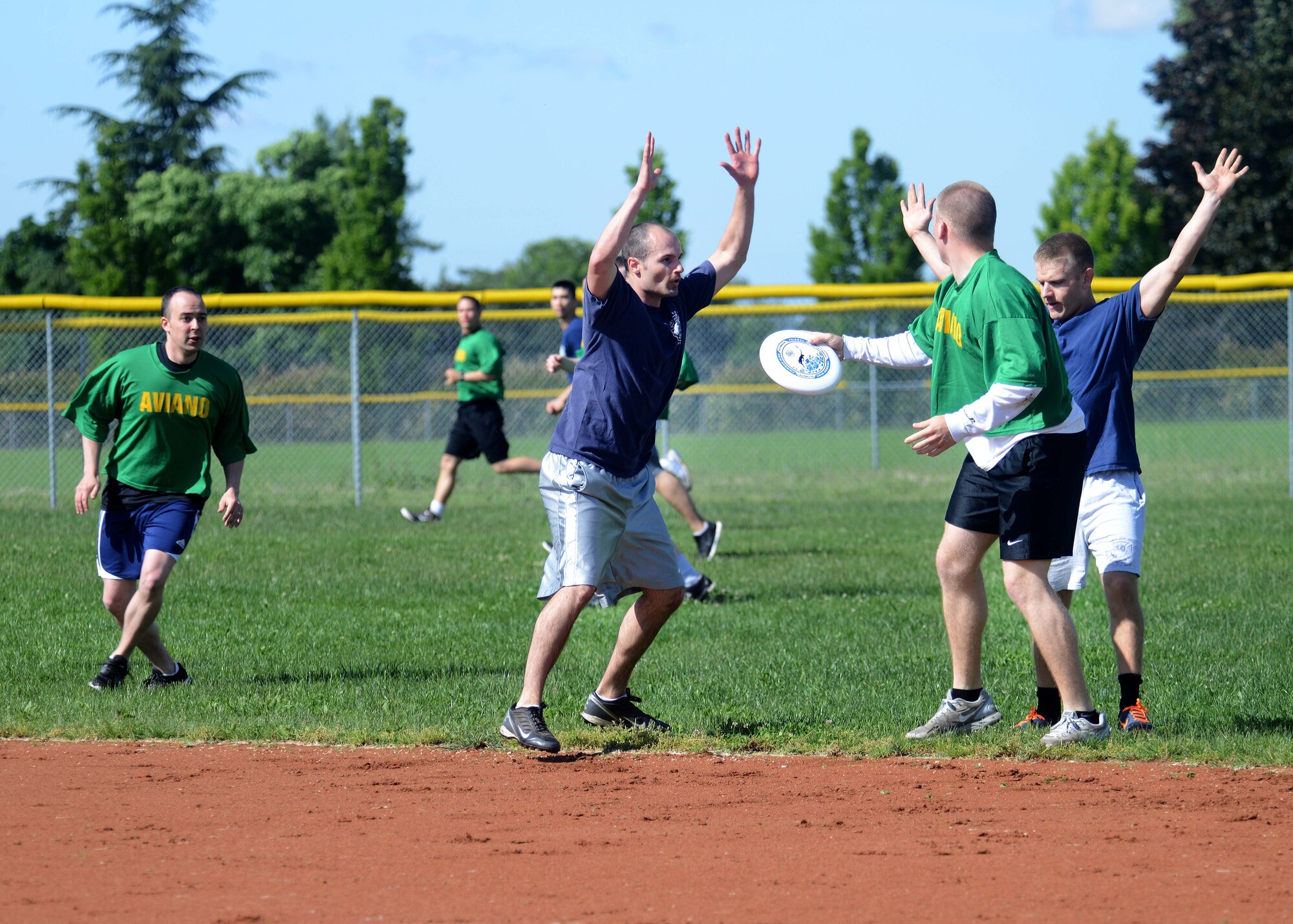 Members of the 31st Security Forces Squadron and 31st Civil Engineer Squadron completed in the annual “Battle of the Badges” during Police Week, May 13, 2014, at Aviano Air Base Italy. The “Battle of the Badges” brought defenders and fire fighters together during a game of Ultimate Frisbee to build morale and camaraderie.  (U.S. Air Force photo/Airman 1st Class Deana Heitzman) 