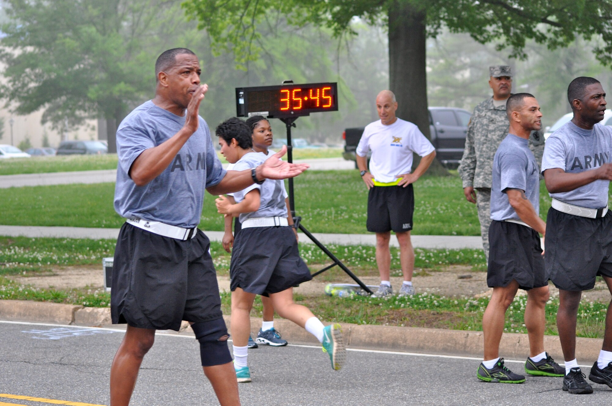 U.S. Army Command Sgt. Maj. James Coleman, 53rd Transportation Battalion, 7th Transportation Brigade (Expeditionary), command sergeant major, stays at the finish line to cheer on Soldiers during the unit’s “4x36” run at Fort Eustis, Va., May 14, 2014. The 4-mile by 36-minute run is an annual XVIII Airborne Corps standard, and part of the Organizational Readiness Assessment.  (U.S. Army photo by Sgt. Stefanie Warner/Released)