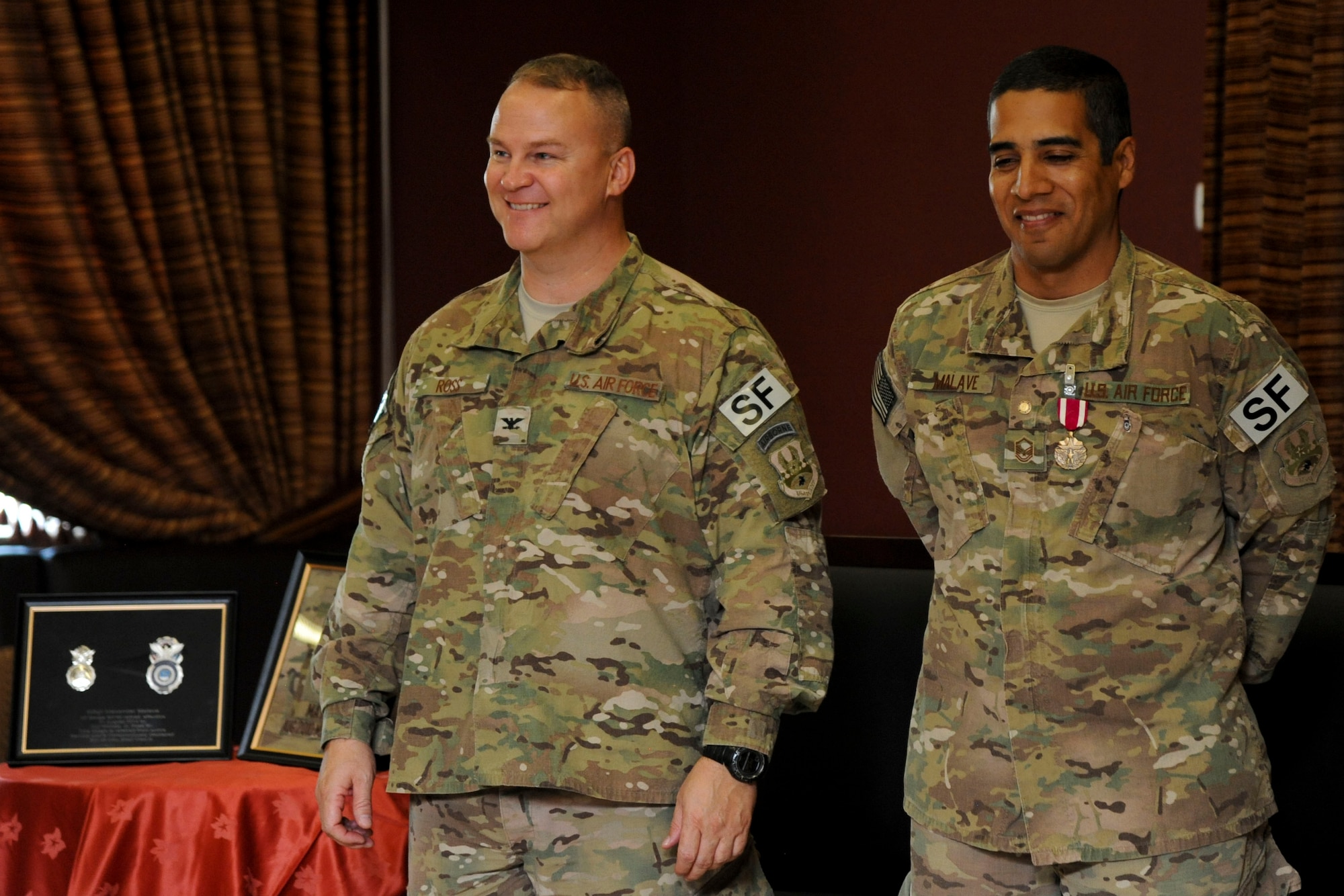 Col. Michael Ross, U.S. Air Forces Central Command force protection commander, officiates the retirement ceremony for Master Sgt. Alexander Malave, U.S. AFCENT force protection NCO in charge, at Al Udeid Air Base, Qatar, May 9, 2014. (U.S. Air Force photo by Senior Airman Michael Ellis/Released)