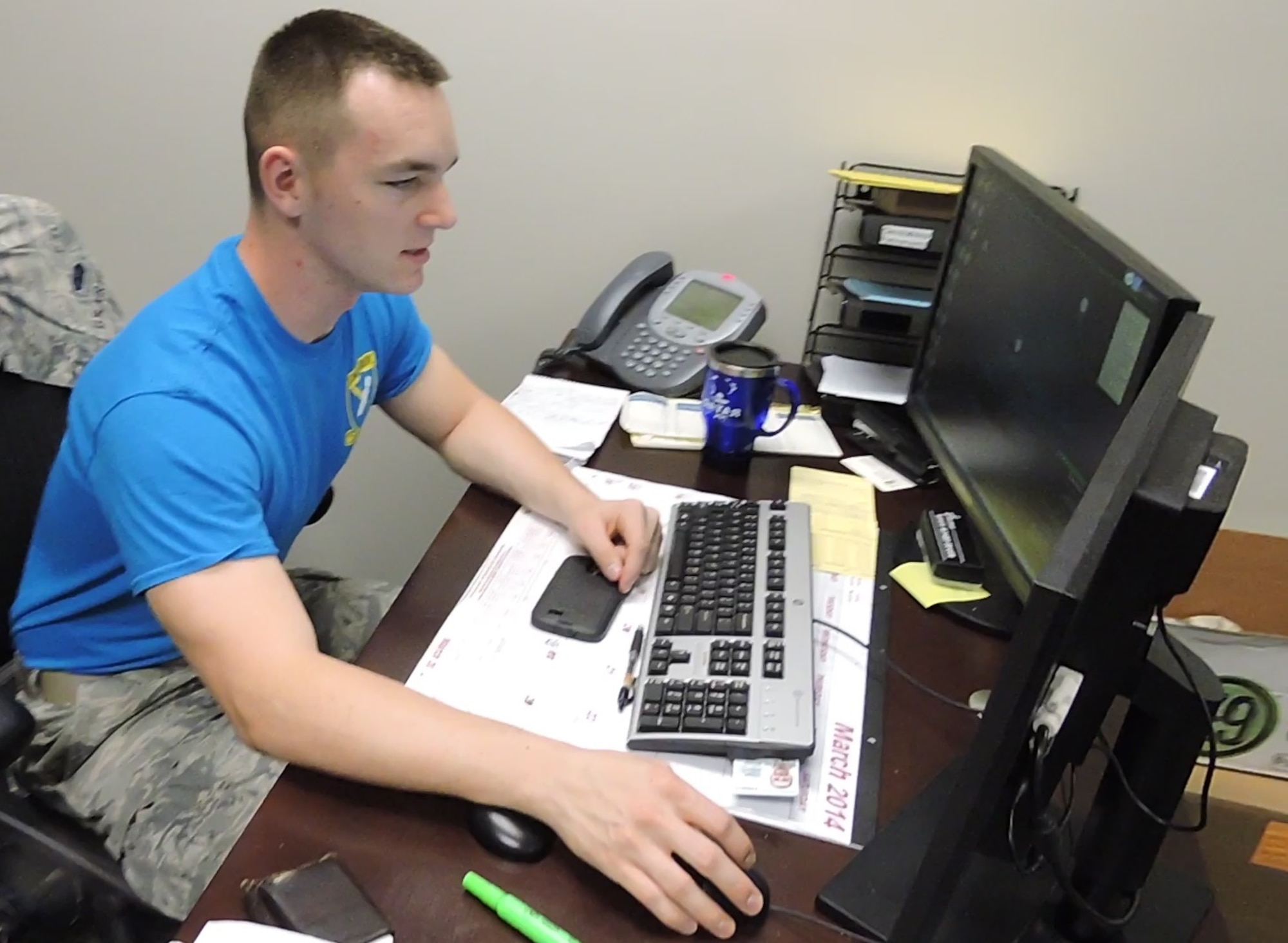 Airman 1st Class Kevin Gasch, 461st Air Control Wing Knowledge Operations manager, sports his morale t shirt May 9. Air Force regulation 35-10 authorizes the wear of unit Morale T-shirts on Fridays across the Air Force.(U.S. Air Force photo by Roland Leach)