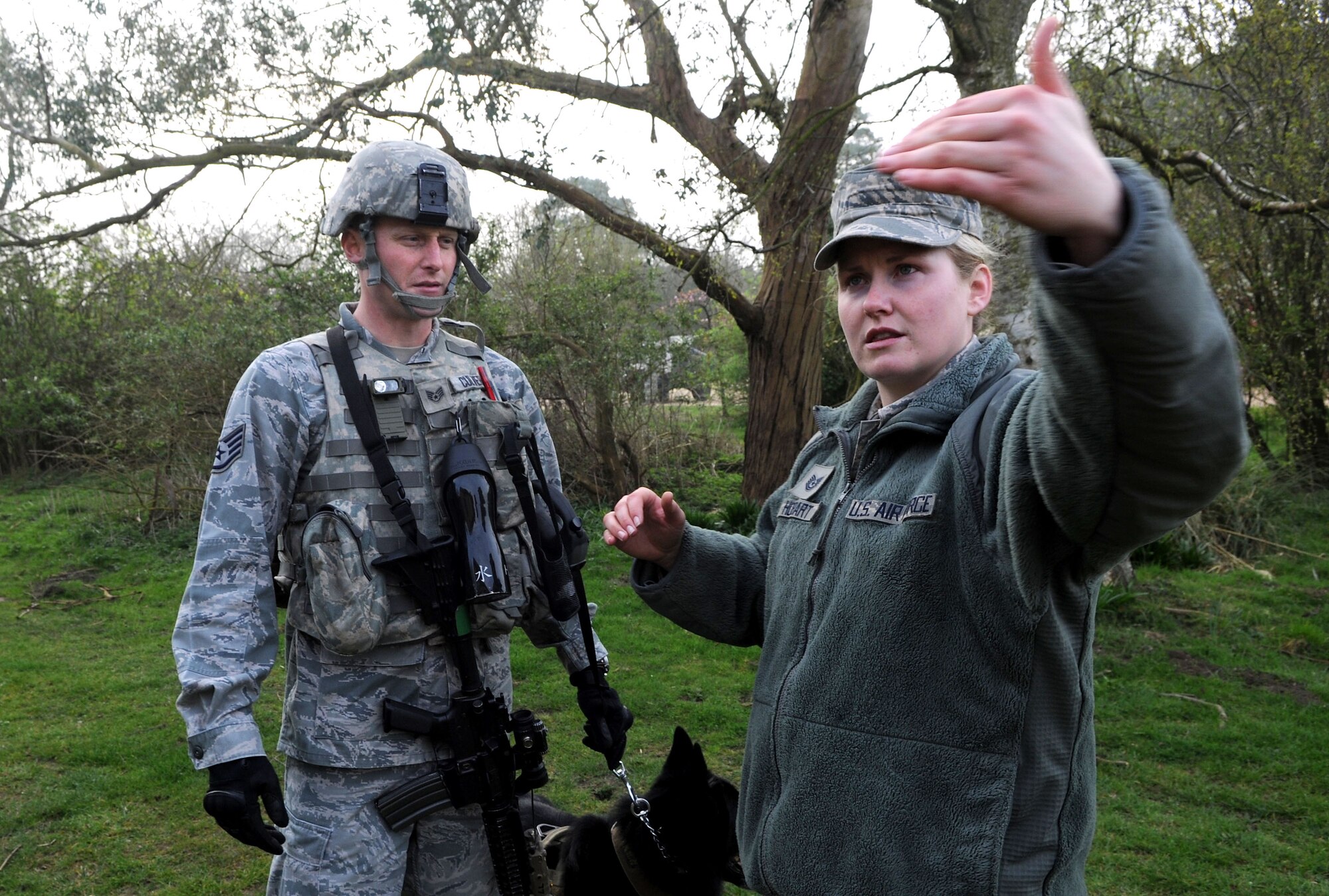 U.S. Air Force Tech. Sgt. Hannah Hobart, right, 100th Security Forces Squadron Military Working Dog kennel master, explains the correct procedure for searching the exterior of a building April 3, 2014, during a training exercise at Stanford Training Area near Thetford, England. After every training session, the MWD team and trainer conduct an after-action report to ensure they met all the training objectivest. It’s important to correct problems in training to ensure the teams achieve the highest degree of excellence in real-world operations.  (U.S. Air Force photo by Senior Airman Kate Maurer/Released)