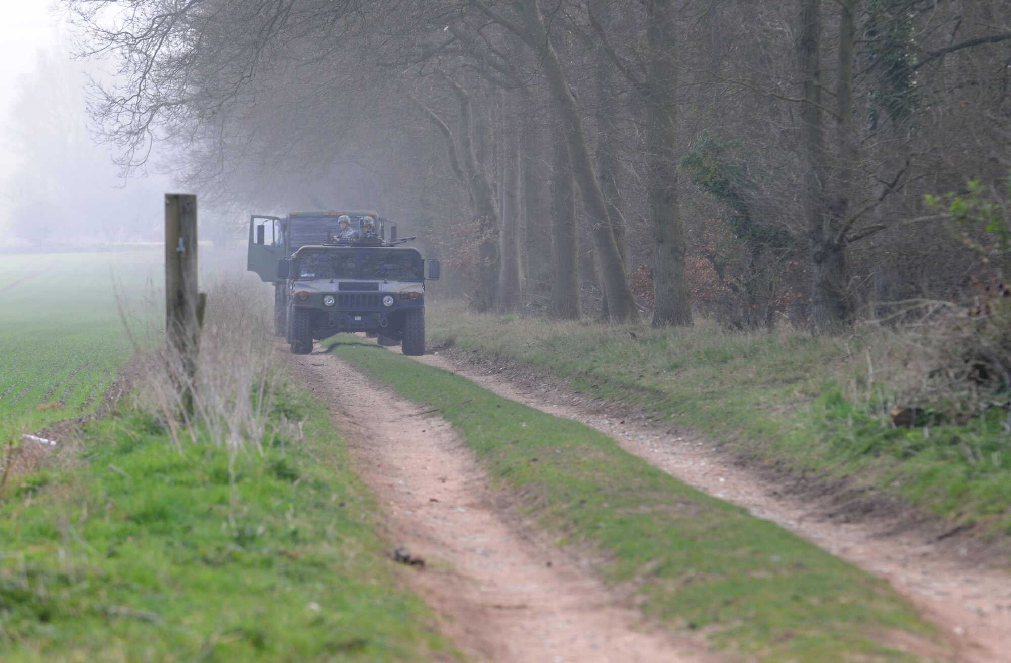 48th Security Forces Squadron members arrive at a training exercise April 3, 2014, at Stanford Training Area near Thetford, England. Security forces Airmen must conduct 40 hours of combat-readiness training before attending an additional training course. The training includes land navigation, dismounted patrols and mounted patrols, small team tactics, convoy operations and fire control measures. (U.S. Air Force photo by Senior Airman Kate Maurer/Released)