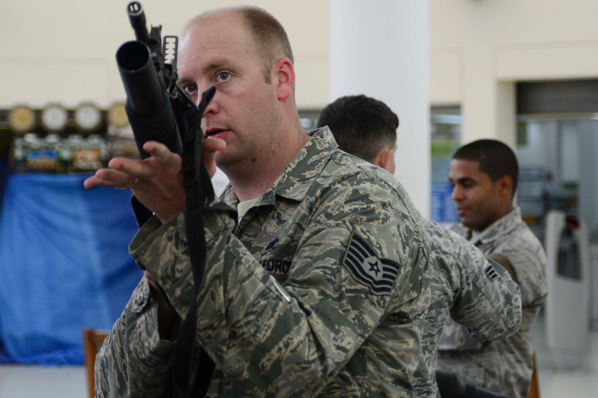 U.S. Air Force Technical Sgt. Timothy Nesbitt, 379th Expeditionary Security Forces Squadron Armory Non-Commissioned Officer looks through the sights of an M4 Carbine w/M203 grenade launcher at Al Udeid Air Base, Qatar, May 16, 2014.  The weapon was part of a weapons display during National Police Week.  Nesbitt is deployed from Tinker Air Force Base and hails from Okinawa, Japan.  (U.S. Air Force photo by Master Sgt. Marcelo Joniaux) 