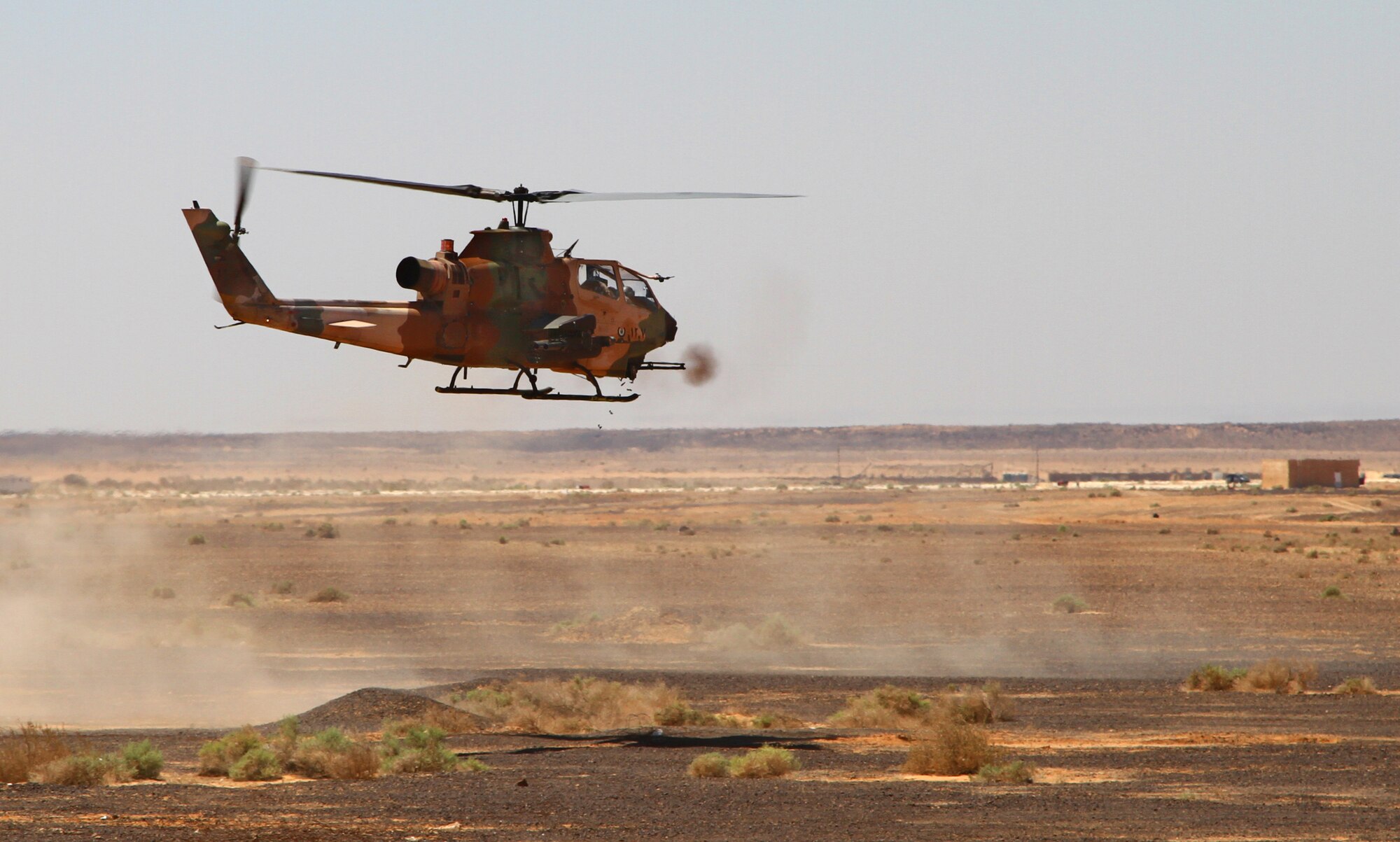 A Royal Jordanian Armed Forces AS332 Super Puma helicopter unloads munitions during a first-run attack competition at Exercise Eager Tiger May 14, 2014, at an air base in northern Jordan. The demonstration of airpower was the final event of the weeklong exercise, which brought together the U.S. and Jordanian militaries for joint training and to emphasize their dedication to regional stability and security. (U.S. Air Force photo by Staff Sgt. Tyler McLain/Released)