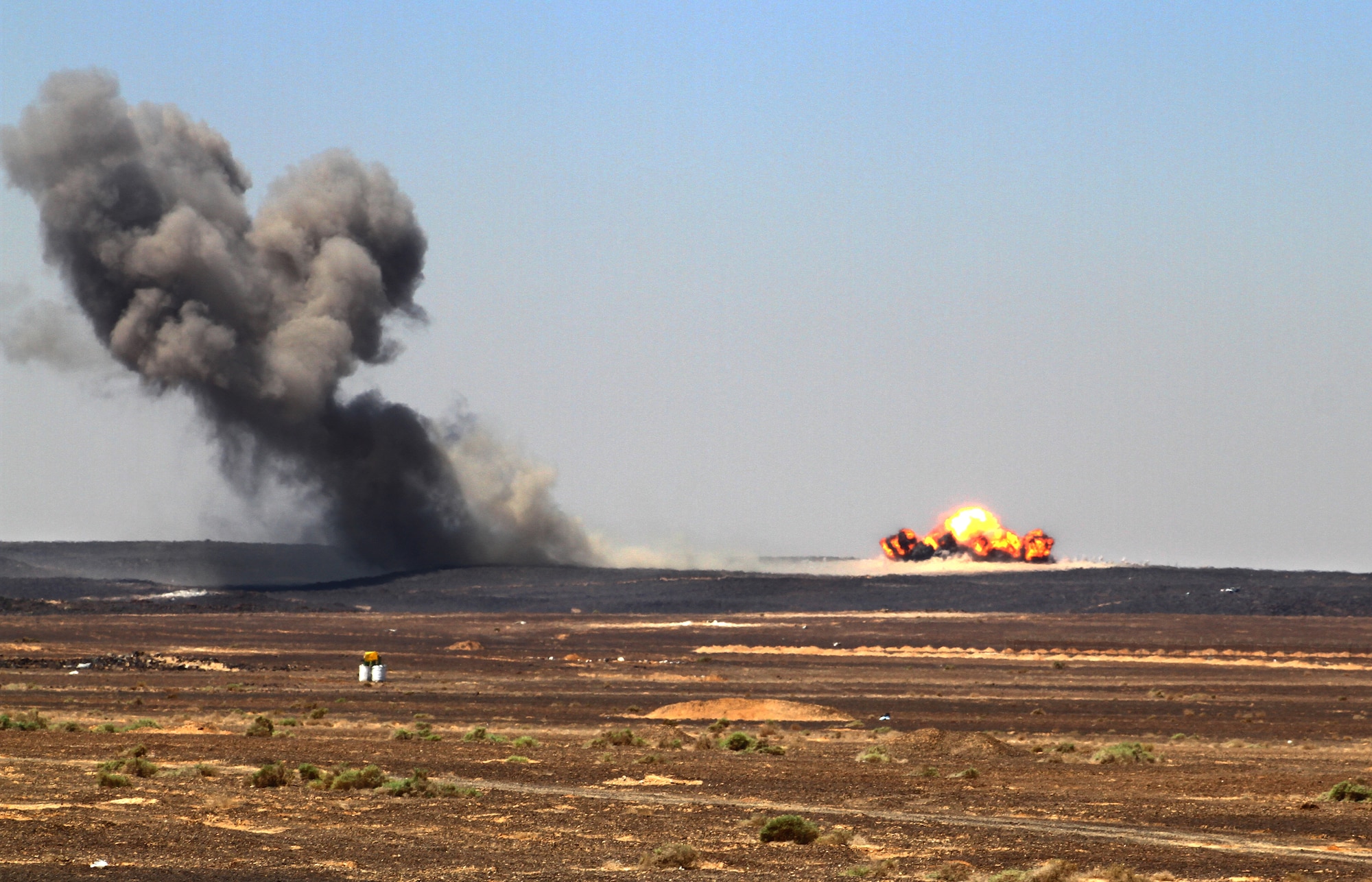 Munitions dropped by aircraft during the first-run attack competition at Exercise Eager Tiger explode May 14, 2014, at an air base in northern Jordan. F-16 Fighting Falcons from the Royal Jordanian Air Force and U.S. Air Force, as well as F-18 Hornets from the U.S. Marine Corps, were scored on their ability to hit the center mass of the specified target. (U.S. Air Force photo by Staff Sgt. Tyler McLain/Released)