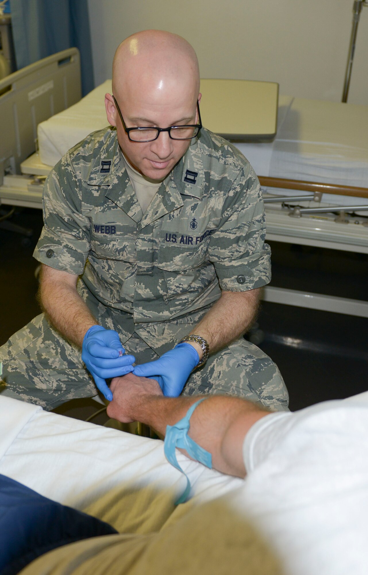 Capt. Gary Webb, 379th Expeditionary Medical Group critical care nurse starts intravenous therapy on a patient May 12, at Al Udeid Air Base, Qatar. Intravenous therapy may be used to correct electrolyte imbalances, to deliver medications, for blood transfusion or as fluid replacement. National Nurses Week is celebrated annually from May sixth and goes through May 12, the birthday of Florence Nightingale, founder of modern nursing. Webb’s home station is Walter Reed National Military Medical Center, and his hometown is Spring, Texas. (U.S. Air Force photo/Senior Airman Colin Cates)
