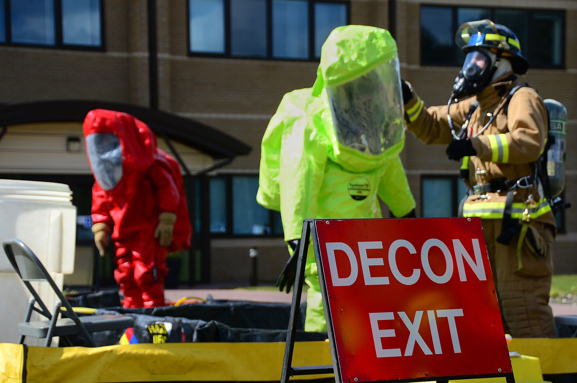 A firefighter from the the 48th Civil Engineer Squadron decontaminates Airman 1st Class Librete Reyes during an exercise at Royal Air Force Lakenheath, England, May 13, 2014. First responders were called out to a simulated chemical incident during a weeklong Unit Effectiveness Inspection. Reyes is an emergency management apprentice assigned to the 48th CES emergency management flight. (U.S. Air Force photo by Airman 1st Class Erin O’Shea/Released)
