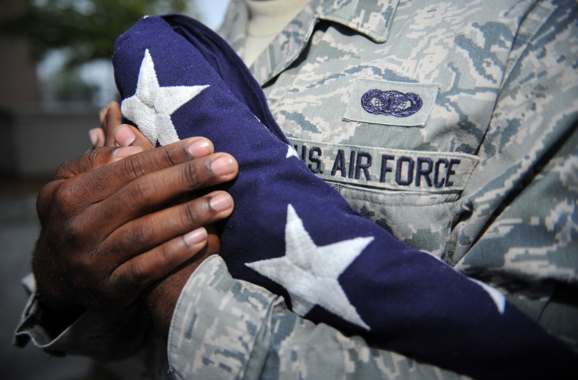 Staff Sgt. Kenneth Morgan, 51st Security Forces Squadron, holds an American flag during the Police Week reveille ceremony at Osan Air Base, Republic of Korea, May 12, 2014. Other Police Week events will include a military working dog demonstration, a ruck march and a retreat ceremony. (U.S. Air Force photo/Airman 1st Class Ashley J. Thum)