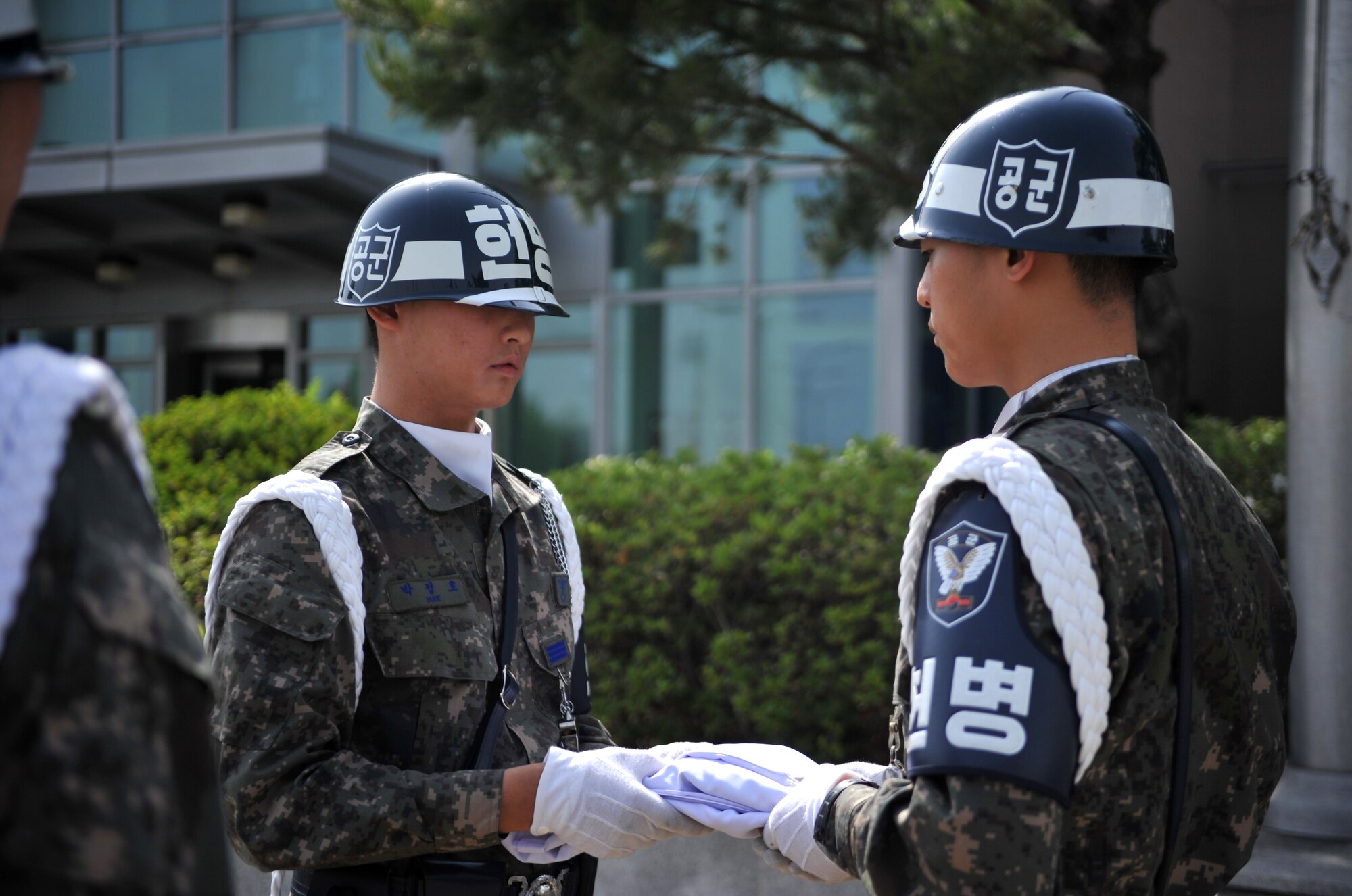 Members of the Republic of Korea air force air police fold the Korean flag during the Police Week retreat ceremony at Osan Air Base, ROK, May 16, 2014. Police Week is an annual tradition centered around National Peace Officers Memorial Day, observed on May 15. (U.S. Air Force photo/Airman 1st Class Ashley J. Thum)
