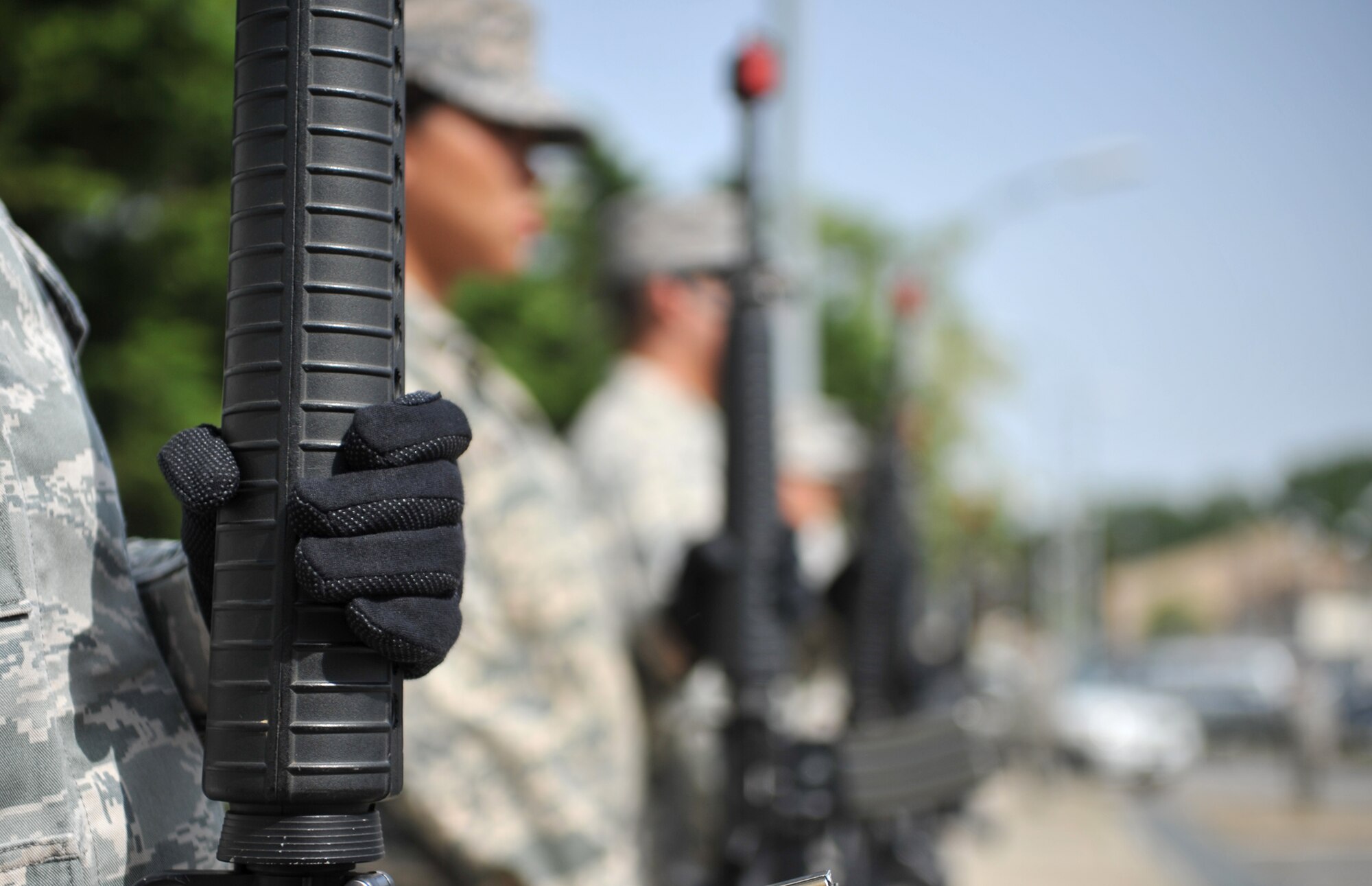 Members of the base honor guard prepare to fire a 21-gun salute during the Police Week retreat ceremony at Osan Air Base, Republic of Korea, May 16, 2014. The 51st Security Forces Squadron hosted various events to commemorate this year’s Police Week, including a reveille ceremony and a four-mile ruck march. (U.S. Air Force photo/Airman 1st Class Ashley J. Thum)