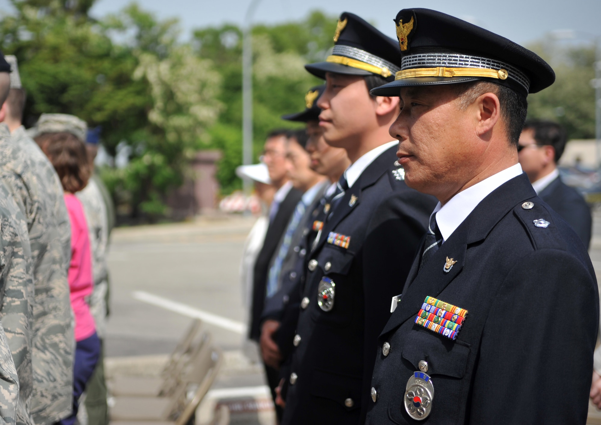 Members of the Korean National Police stand to show respect for the reading of fallen law enforcement officers’ names during the Police Week retreat ceremony at Osan Air Base, Republic of Korea, May 16, 2014. The 51st Security Forces Squadron strives to maintain a strong partnership with their Korean counterparts. (U.S. Air Force photo/Airman 1st Class Ashley J. Thum)