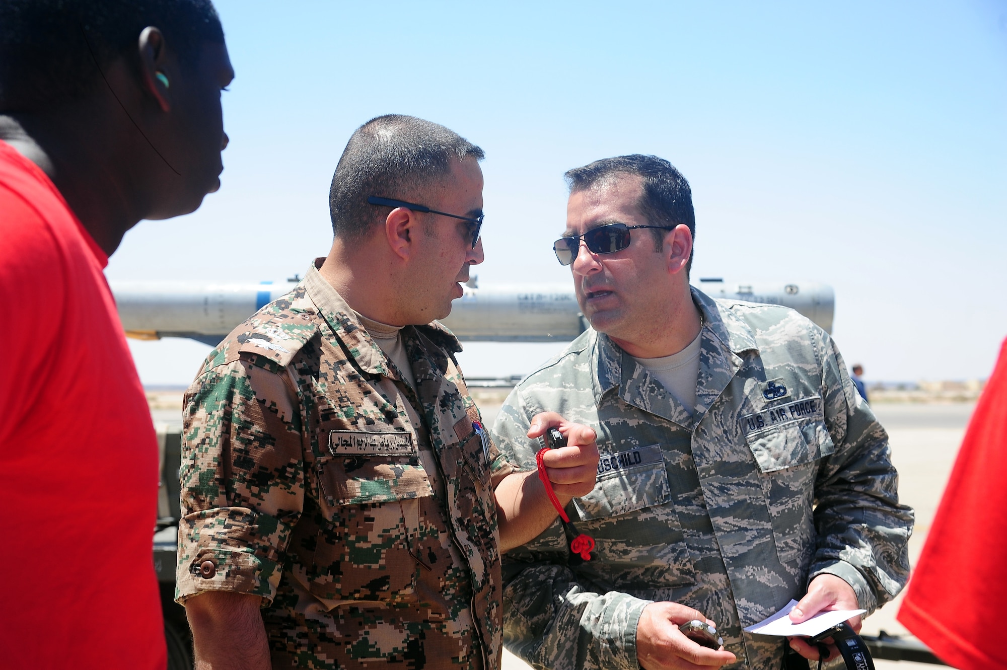 U.S. Air Force Chief Master Sgt. Edward Hauschild, the munitions superintendent from the 140th Maintenance Squadron from the Colorado Air National Guard, talks to a member of the Royal Jordanian Air Force after a load competition during Exercise Eager Tiger May 11, 2014, at an air base in northern Jordan. For 10 years, the COANG and Jordan have been paired under the National Guard Bureau's State Partnership Program, which aims to partner states and countries for a mutually beneficial relationship. (U.S. Air Force photo by Staff Sgt. Brigitte N. Brantley/Released)
