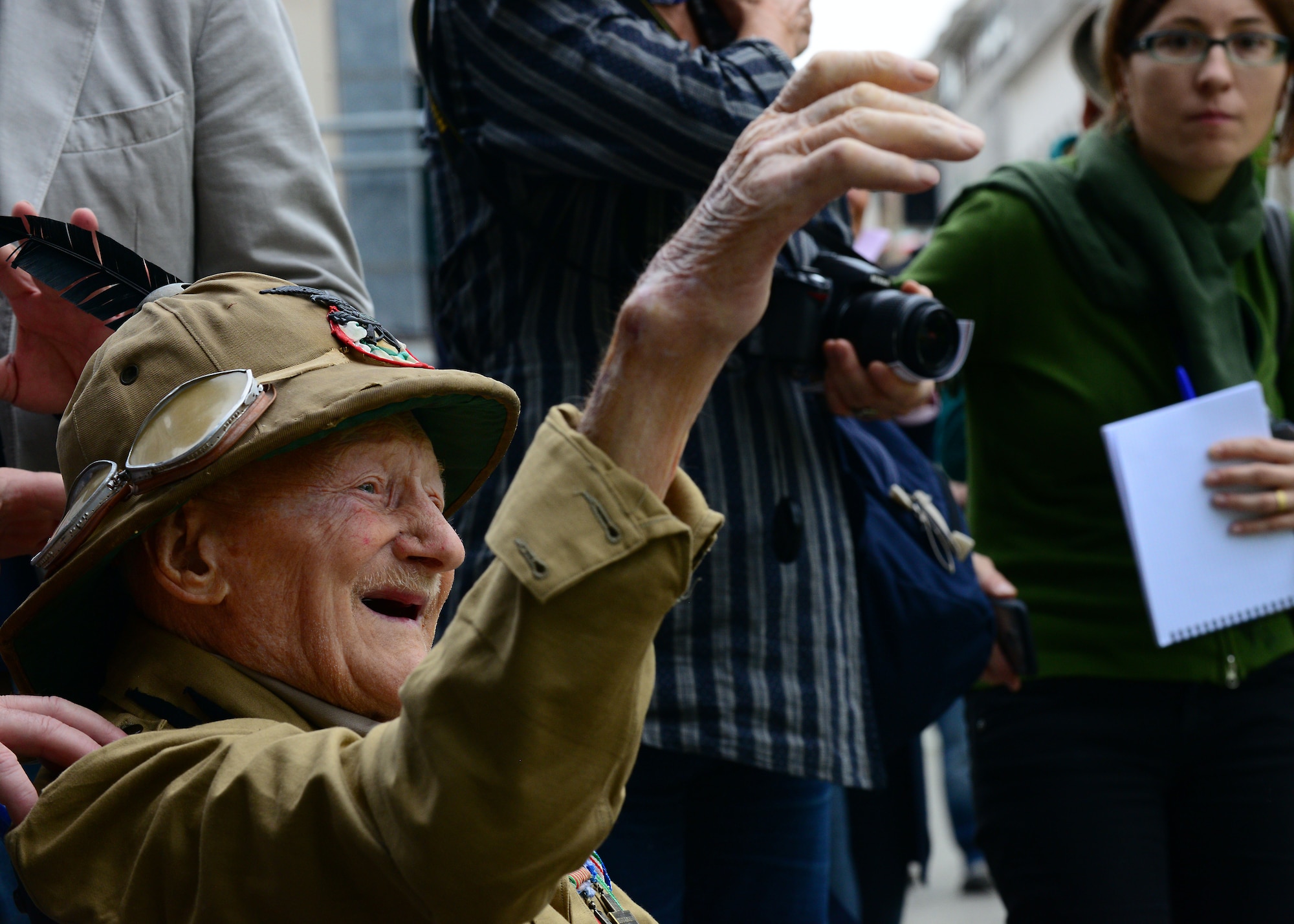 A man, who onlookers said was the oldest surviving member of the Alpini Corps at 101 years old, cheers for the passing parade, May 11, 2014, in downtown Pordenone, Italy. More than 75,000 Alpini troops marched through the streets to commemorate the 87th gathering of the mountain soldiers of Italy. (U.S. Air Force photo/Airman 1st Class Ryan Conroy) 