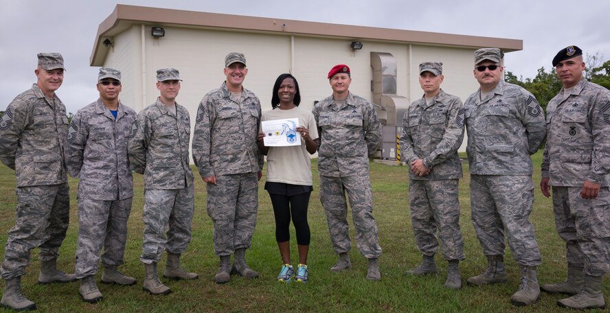 (Center) Tech. Sgt. Tijuana S. Perry, 320th Special Tactics Squadron NCO in charge of Aviation Resource Management, is selected as Kadena's April 2014 Chief's Choice Award recipient. Among her accomplishments, Perry helped her squadron through an inspector general inspection, was the lead Sexual Assault Prevention and Response facilitator for her squadron during the 18th Wing's SAPR Down Day, and coached youth cheerleading. Each month, the Kadena Chiefs' Group recognizes individuals for outstanding professionalism, customs, courtesies, bearing, and or civic contributions to Team Kadena. By publicly recognizing these core leadership and followership attributes the Chiefs' Group reinforces the intrinsic value these attributes possess. (Courtesy photo)