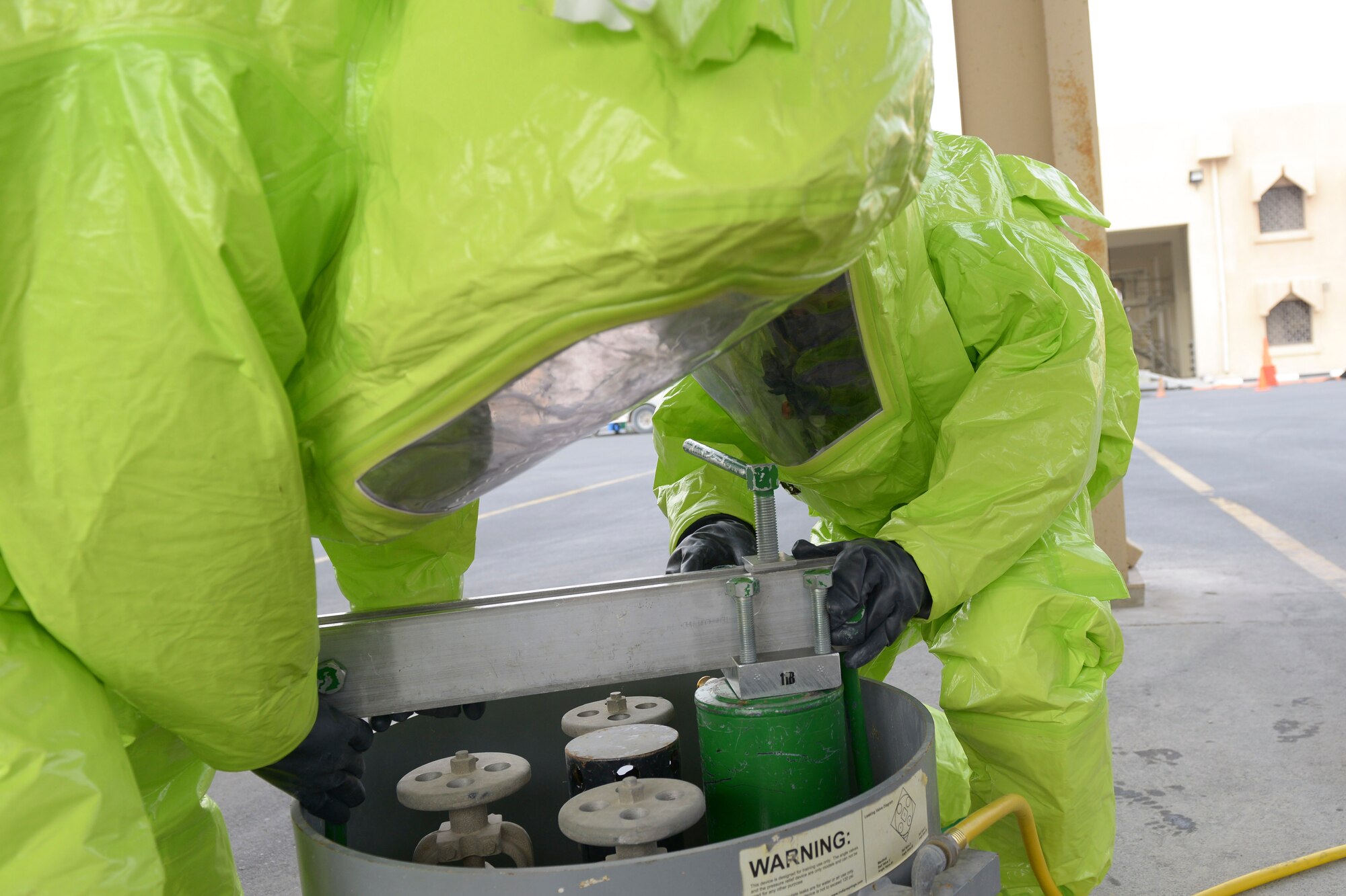 Senior Airman Chrisili Villasenor and Airman First Class Kile Larsen, 379th Expeditionary Civil Engineer Squadron firefighters, contain a hazardous material leak during a Hazmat qualification exercise May 10, at Al Udeid Air Base, Qatar. This exercise was completed to accomplish the annual requirements for Hazmat exercises. Villasenor’s home station is Joint Base Langley-Eustis, Virginia, and his hometown is Siloam Springs, Arkansas. Larsen’s home station is Joint Base Elmendorf-Richardson, Alaska, and his hometown is Emmett, Idaho (U.S. Air Force photo/Senior Airman Colin Cates)