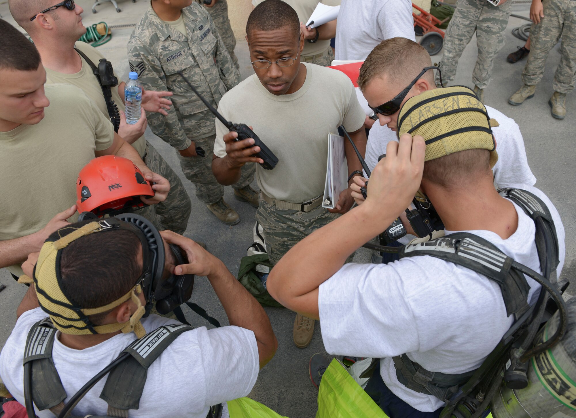 Firefighters from the 379th Expeditionary Civil Engineer Squadron are briefed before a Hazardous Materials qualification exercise May 10, at Al Udeid Air Base, Qatar. Five firefighter received their hazardous materials Technician Certification that day. The firefighters were nationally certified from International Fire Service Accreditation Congress. (U.S. Air Force photo/Senior Airman Colin Cates)
