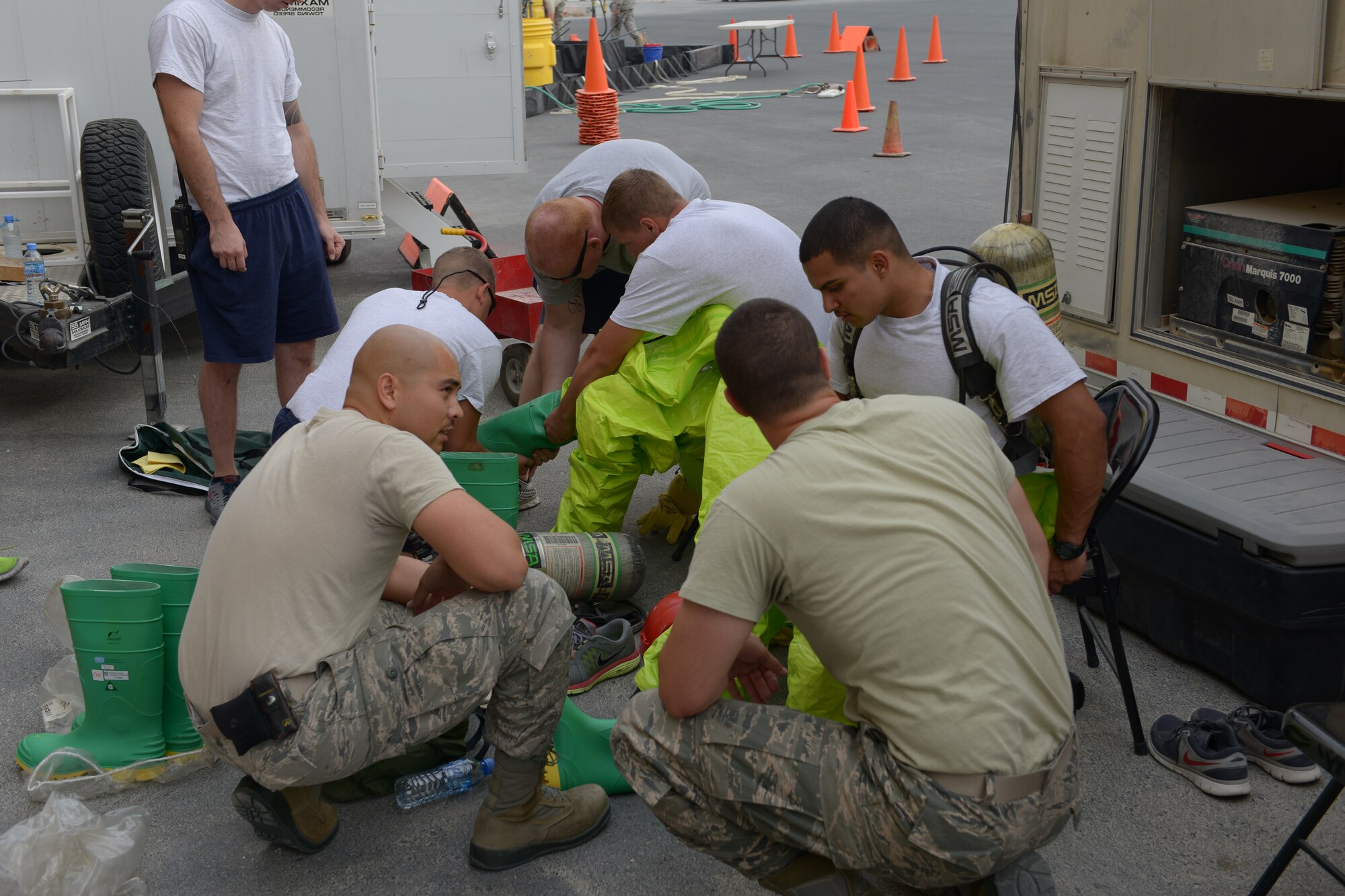 Firefighters from the 379th Expeditionary Civil Engineer Squadron prepare for a hazardous Materials qualification exercise May 10, at Al Udeid Air Base, Qatar. The firefighters wore Level A Hazmat suits which provides the highest level of protection against vapors, gases, mists, and particles. The firefighters were nationally HazMat certified, from International Fire Service Accreditation Congress.(U.S. Air Force photo/Senior Airman Colin Cates)