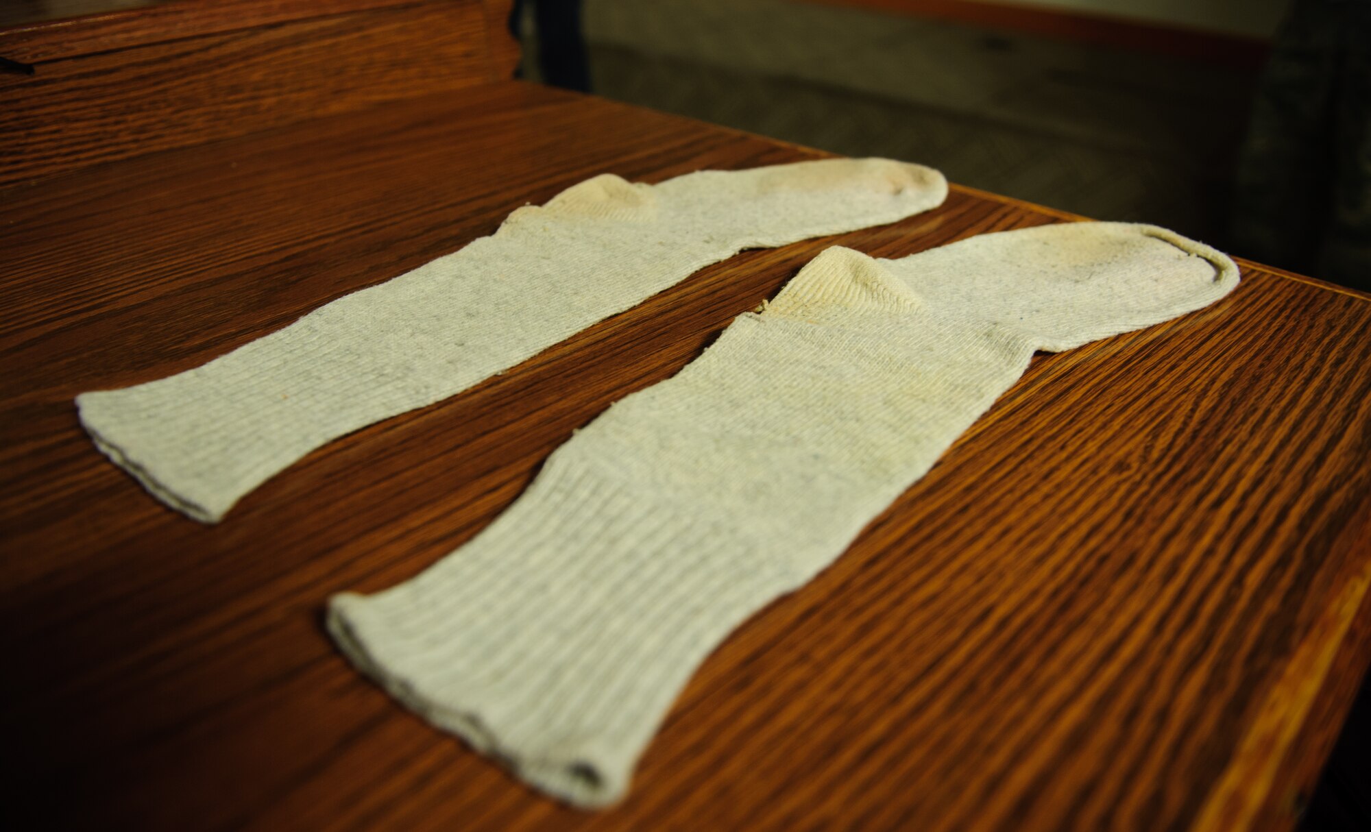 Retired Air Force Brig. Gen. Robin Olds’ lucky socks returned to the 8th Fighter Wing at Kunsan Air Base, Republic of Korea, May 13, 2014. Until recently, the socks were cared for by John Dibbs, The Plane Picture Company creative director and friend of Olds. He presented the memento to be cared for by the Wolf Pack and inspire future leaders. Olds, known as “Wolf 1,” reportedly wore the socks during every mission he flew. (U.S. Air Force photo by Senior Airman Armando A. Schwier-Morales/Released)