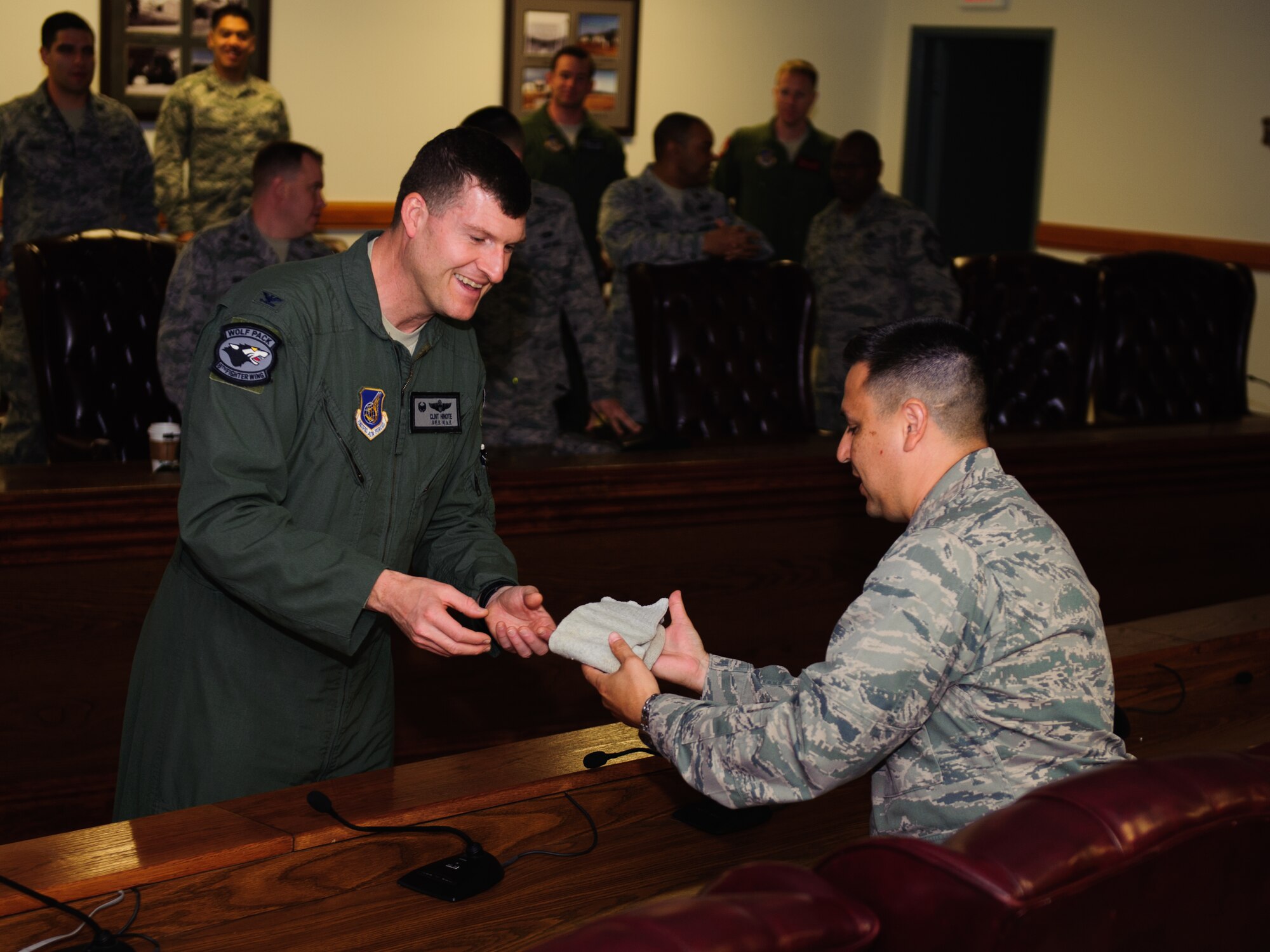Col. S. Clinton Hinote, Wolf 53 and previous 8th Fighter Wing commander, passes retired Air Force Brig. Gen. Robin Olds’ lucky socks to Lt. Col. Marcos Garcia, 8th Force Support Squadron commander, to be displayed in the Olds Room, at Kunsan Air Base, Republic of Korea, May 13, 2014. Dibbs presented the memento to be cared for by the Wolf Pack and inspire future leaders. Olds, known as “Wolf 1,” reportedly wore the socks during every mission he flew. (U.S. Air Force photo by Senior Airman Armando A. Schwier-Morales/Released)