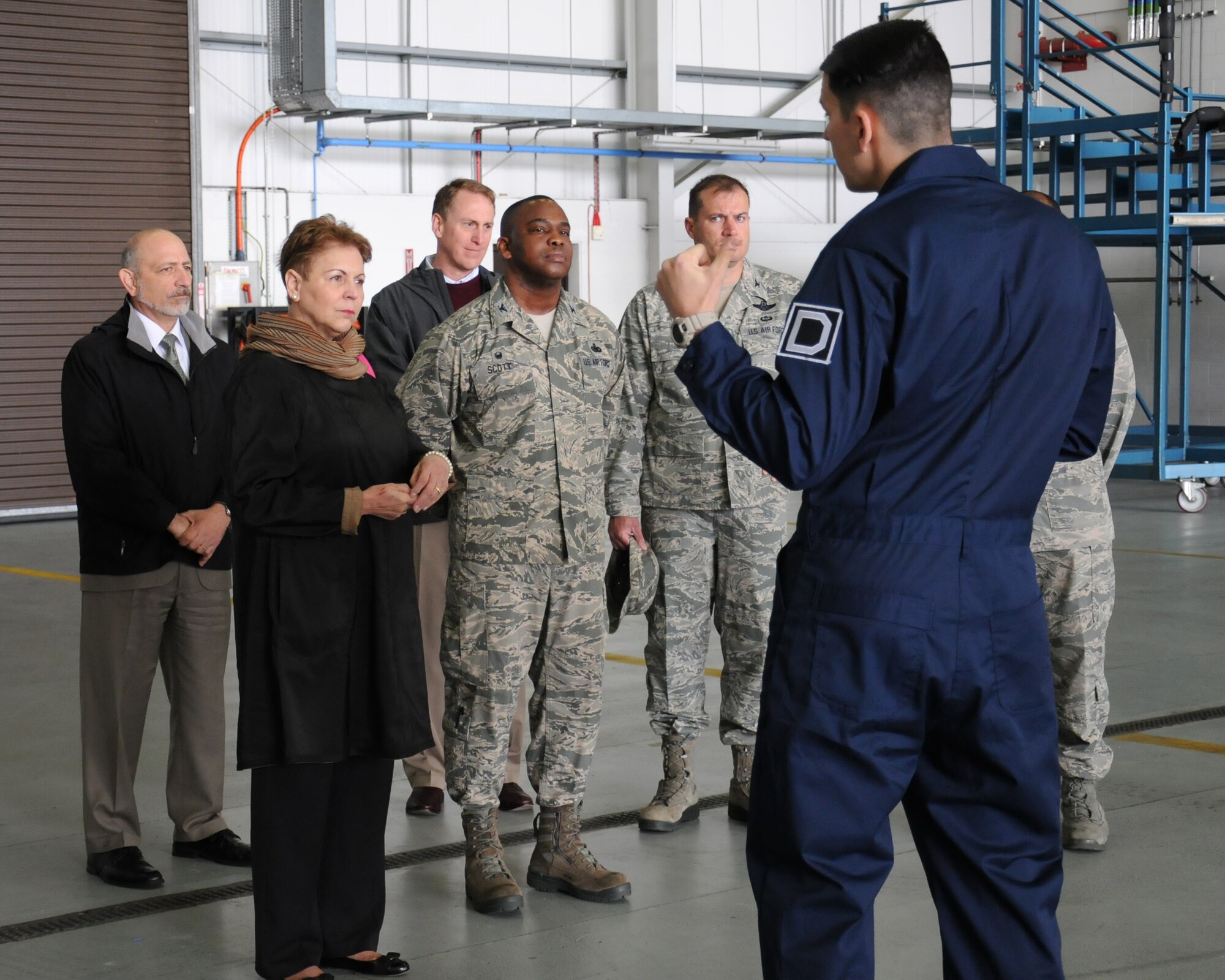 U.S. Air Force Staff Sgt. Michael Bouvier, right, 100th Aircraft Maintenance Squadron dedicated flying crew chief from Paris, speaks with The Honorable Jessica Wright, second from left, acting undersecretary of defense for personnel and readiness, May 14, 2014, on RAF Mildenhall, England. Wright toured the base with Team Mildenhall leadership and met Airmen who told her about their careers. Wright began her military career as an enlisted soldier in the Pennsylvania Army National Guard in 1975, after graduating from Alderson Broaddus College with a bachelor's degree in social work. (U.S. Air Force photo by Gina Randall/Released)