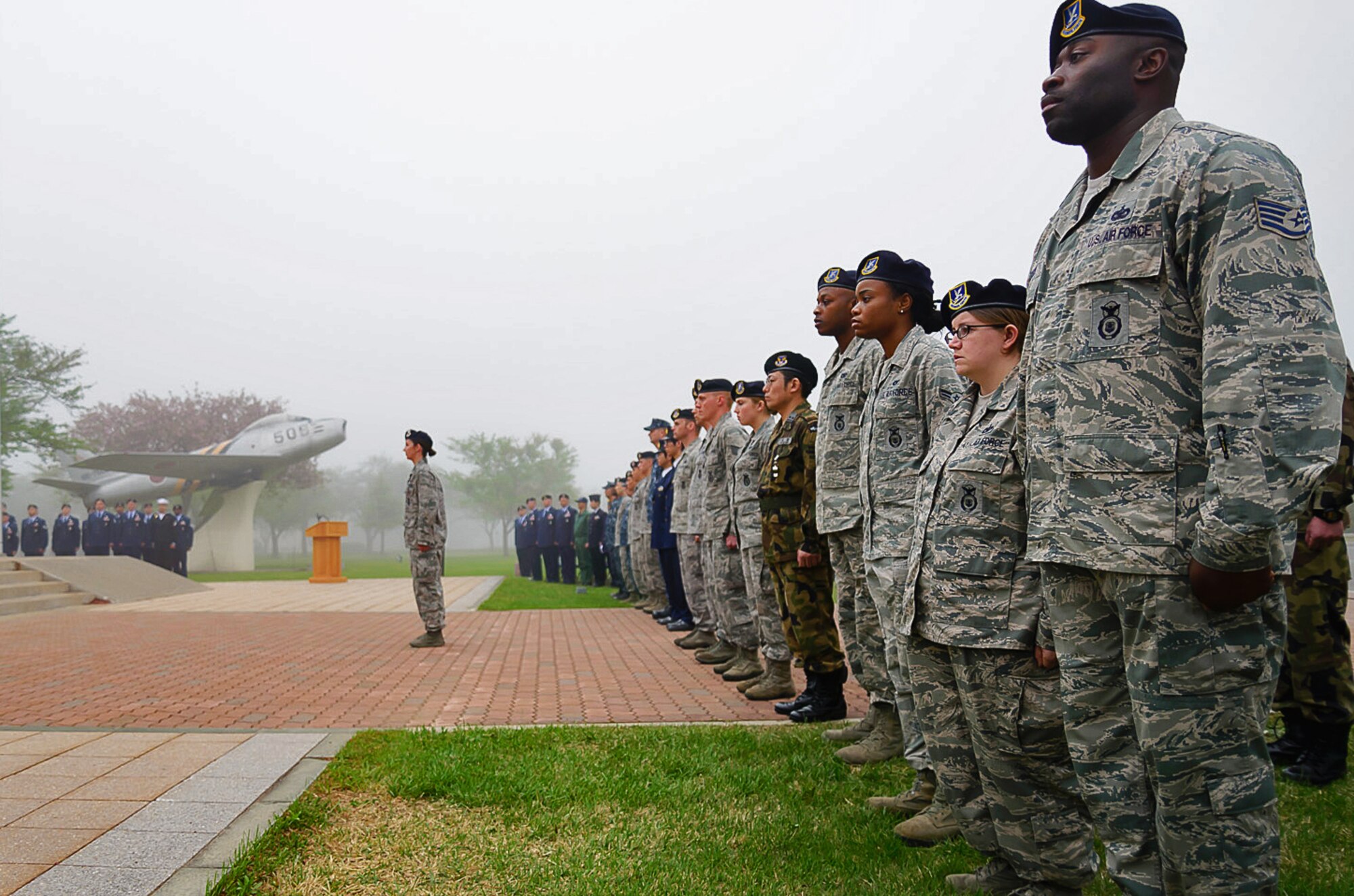 35th Security Forces Squadron Airmen, alongside Japanese Self-Defense Forces security members, stand at attention during a Peace Officers Memorial Day retreat ceremony at Misawa Air Base, Japan, May 15, 2014. The 35 SFS hosted events like a K-9 demonstration, a ruck march, and a public show with local Japanese police officers in recognition of National Police Week. (U.S. Air Force photo/Staff Sgt. Jared Elliott)